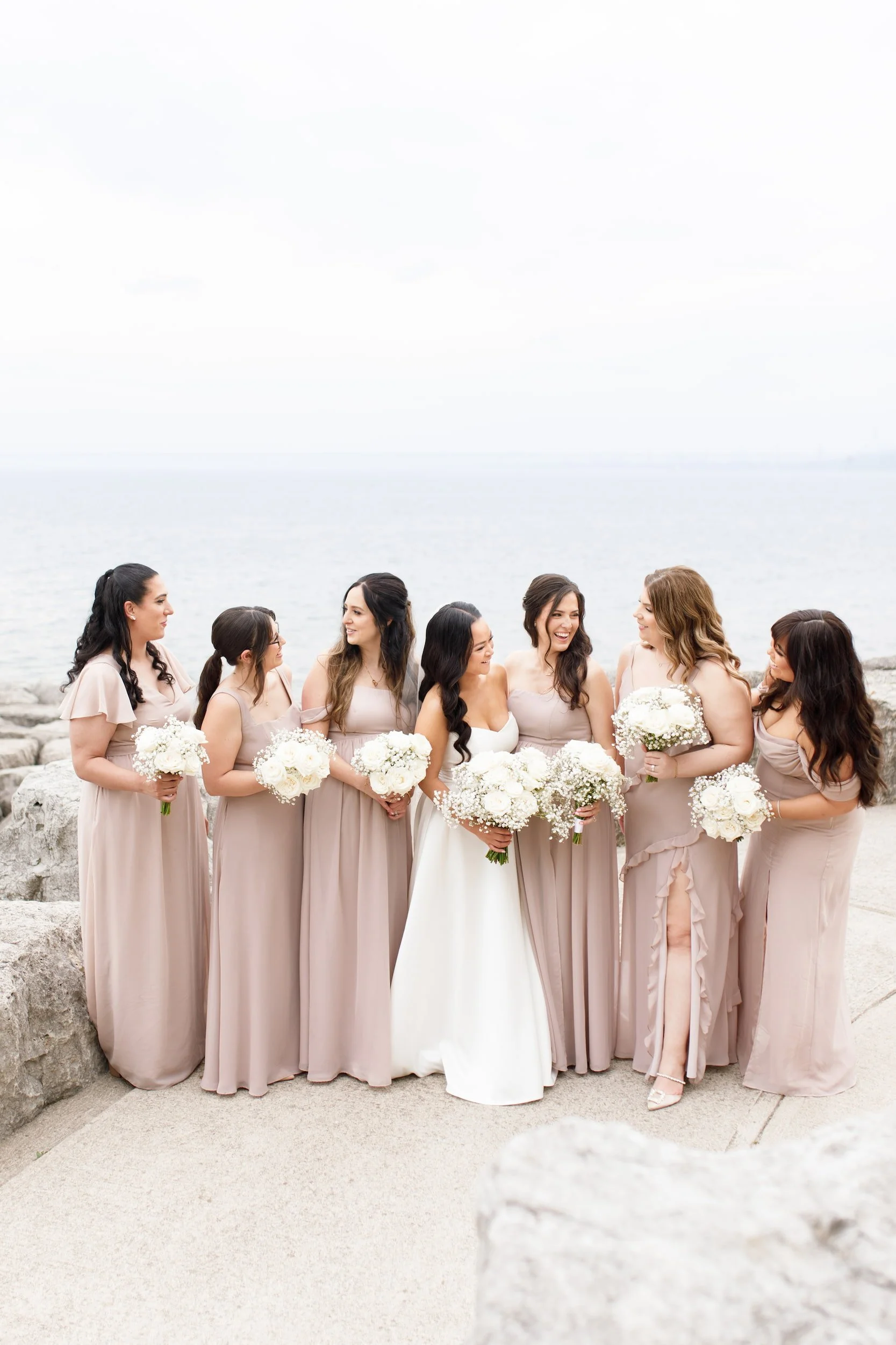 Bridesmaids portrait on Lake Ontario shoreline near The Pearle Hotel in Burlington, Ontario