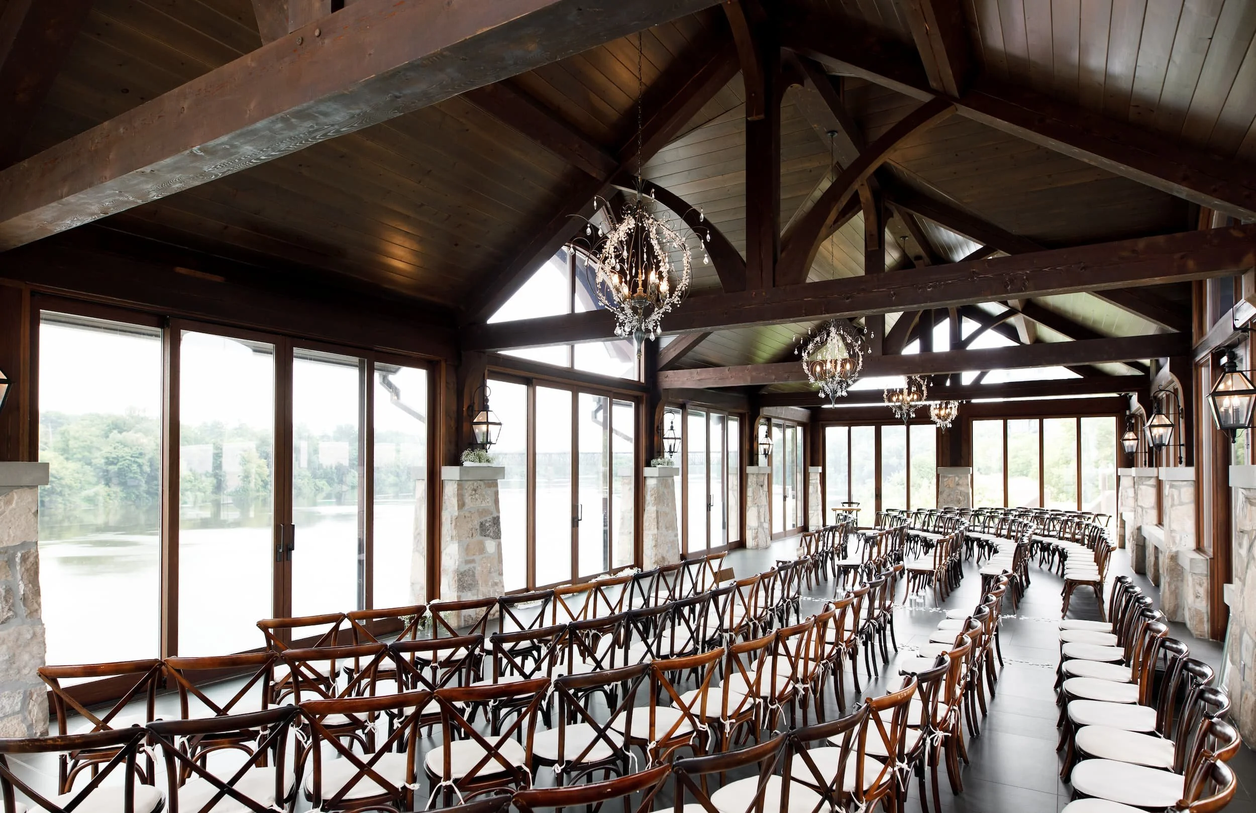 Rustic-modern ceremony space with exposed wood beams at Cambridge Mill in Cambridge, Ontario