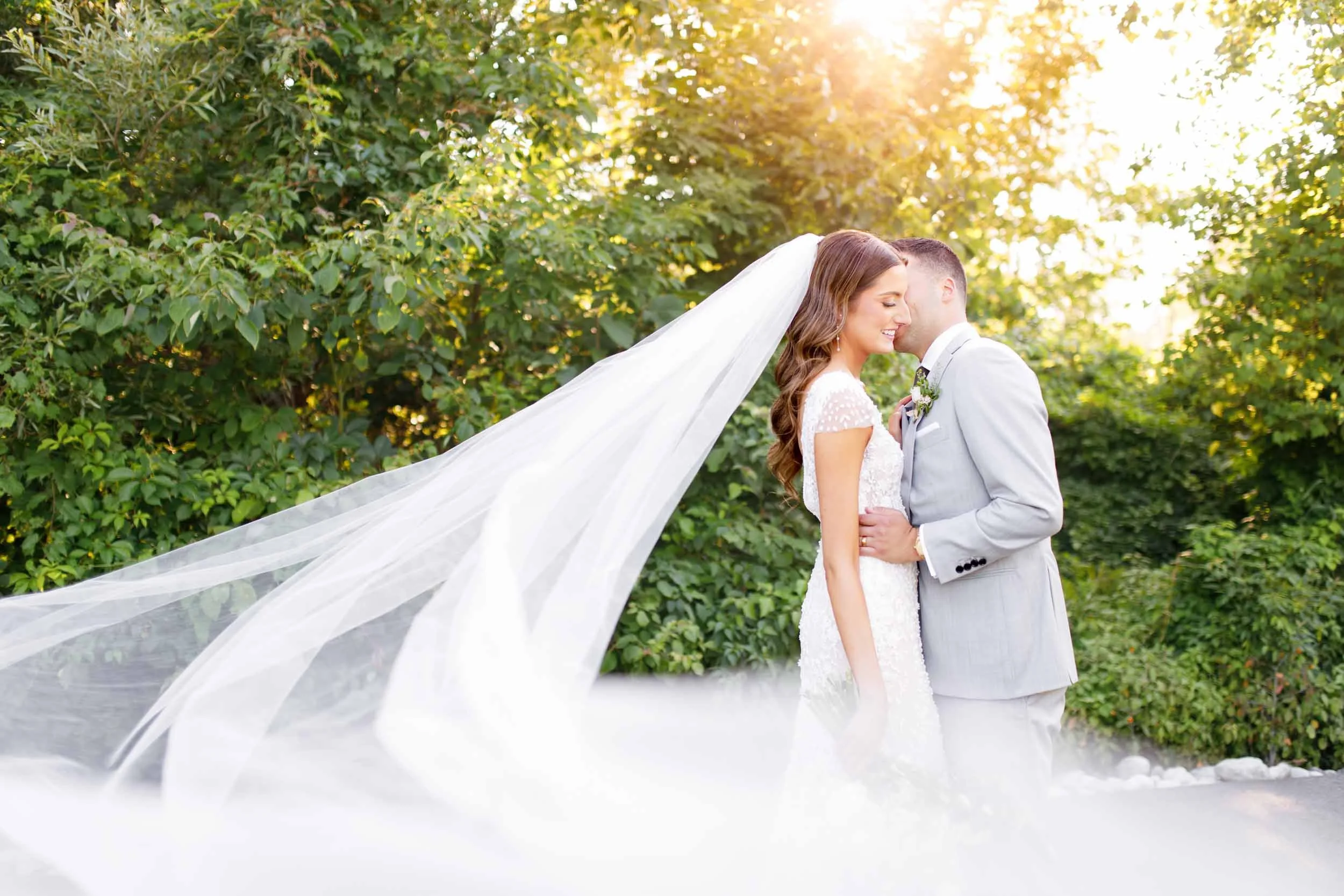 Bride and groom embracing with flowing veil at Whistle Bear Golf Club in Cambridge, Ontario