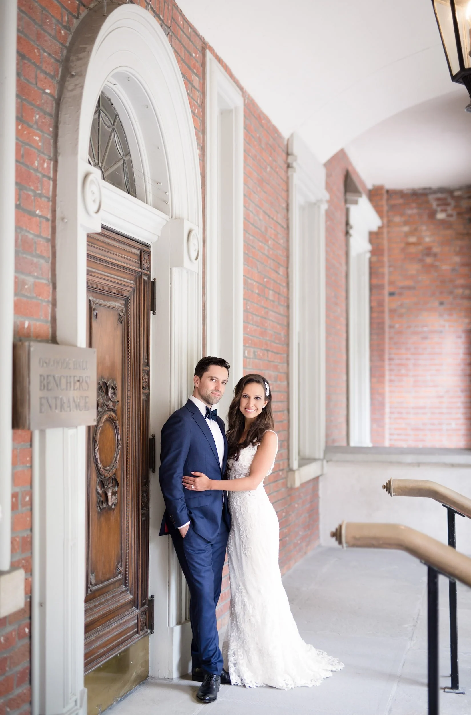 Wedding couple portrait along covered corridor at Osgoode Hall in Toronto