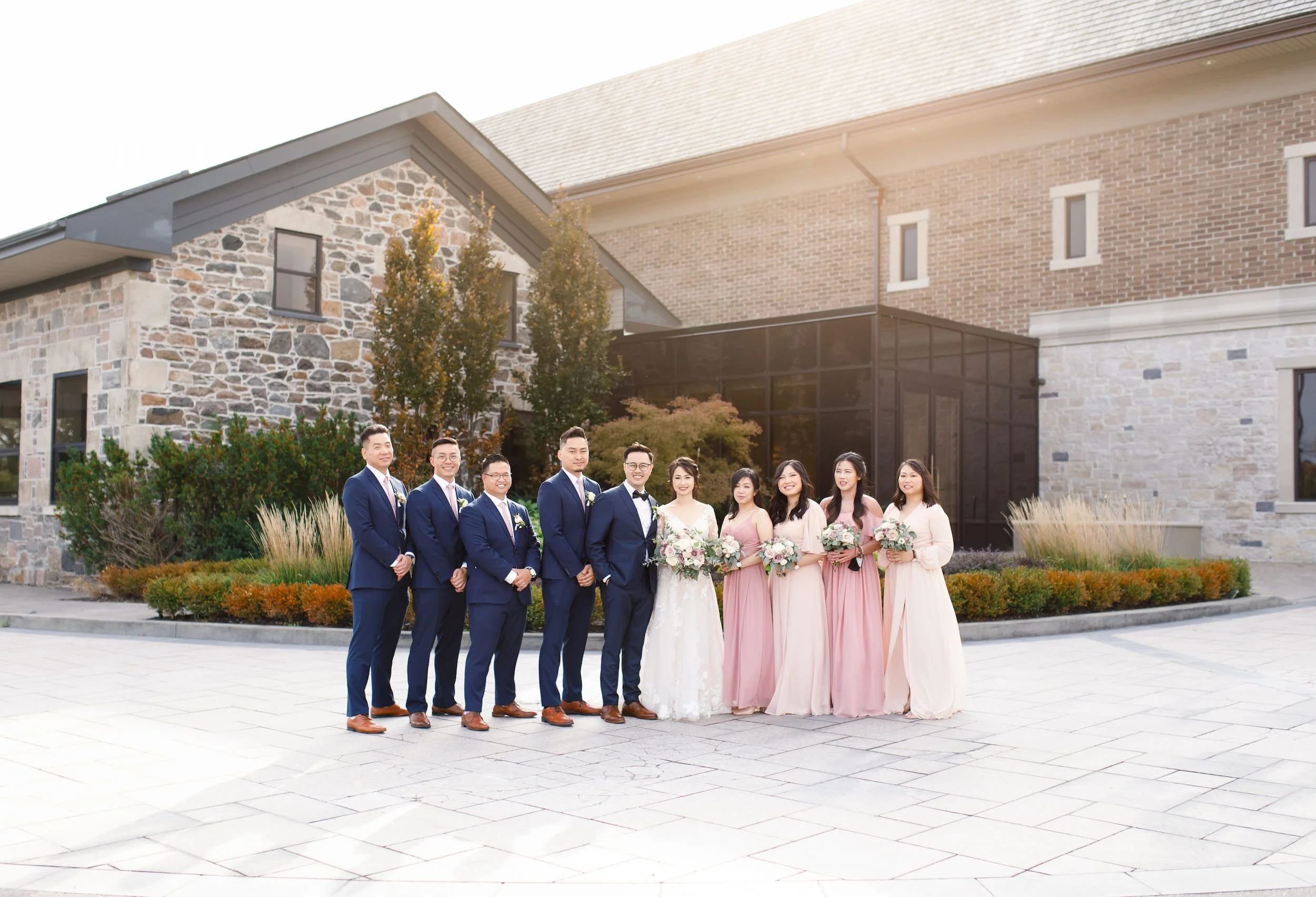 Wedding party portrait in front of the Arlington Estate stone façade in Vaughan