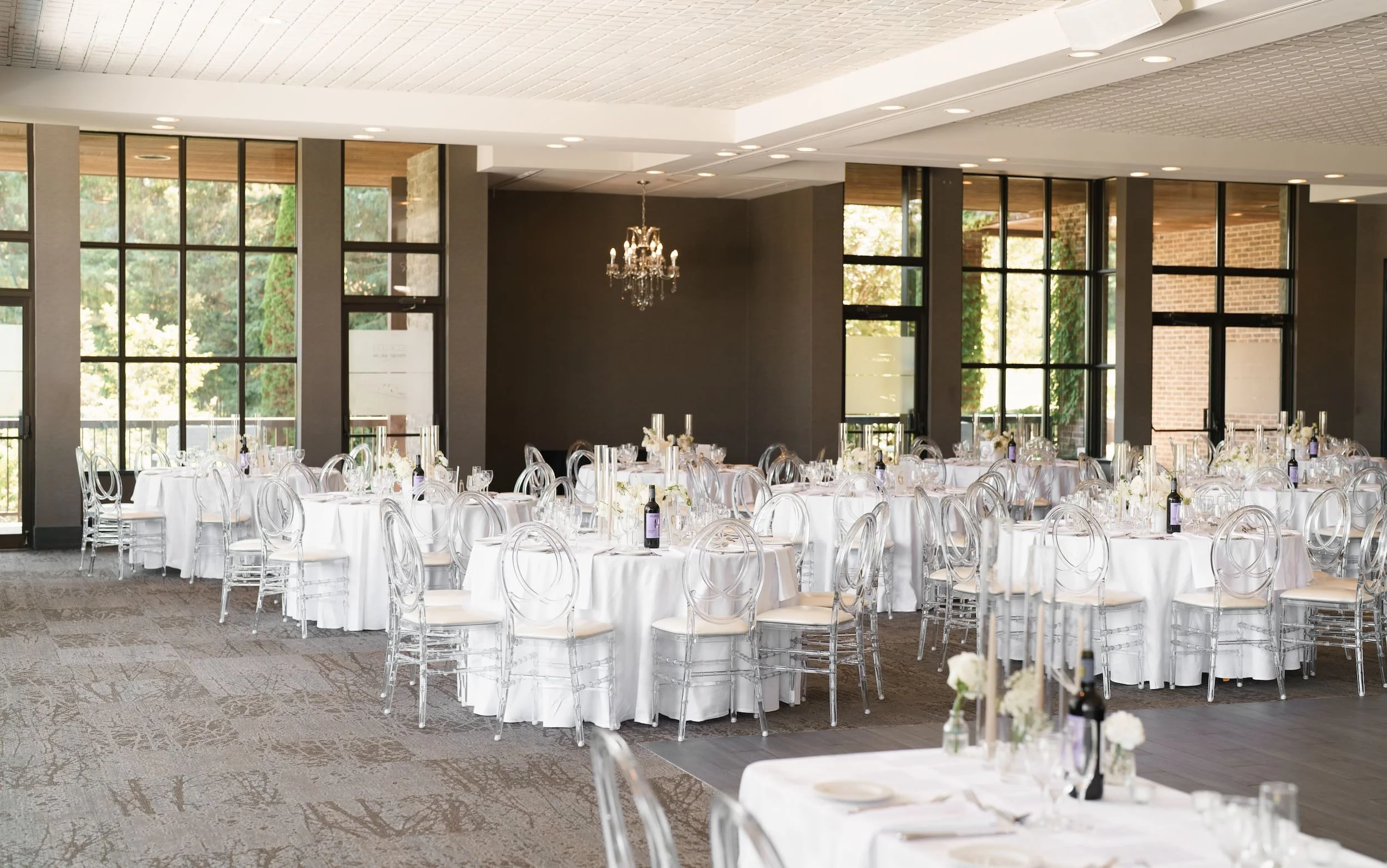 Elegant ballroom reception setup with crystal chairs at The Manor Event Venue wedding in King, Ontario