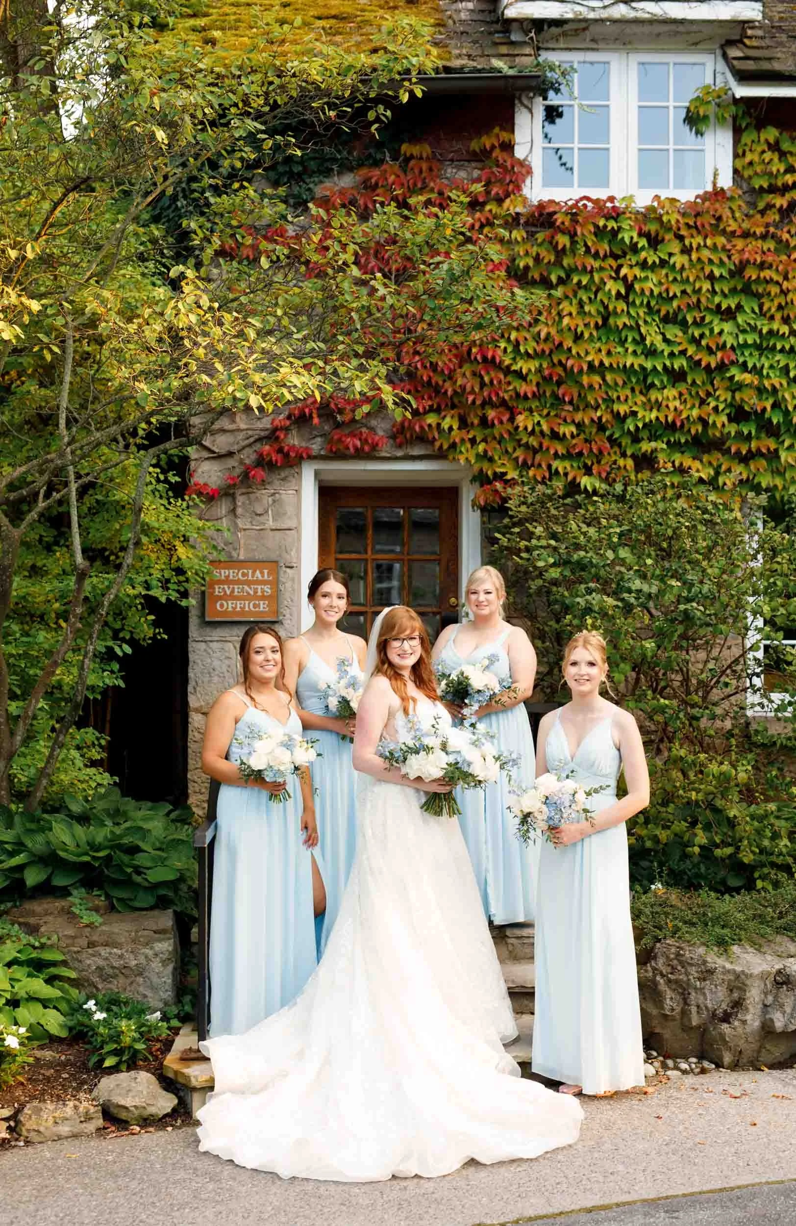 Bridesmaids portrait at the ivy-covered Ancaster Mill entrance