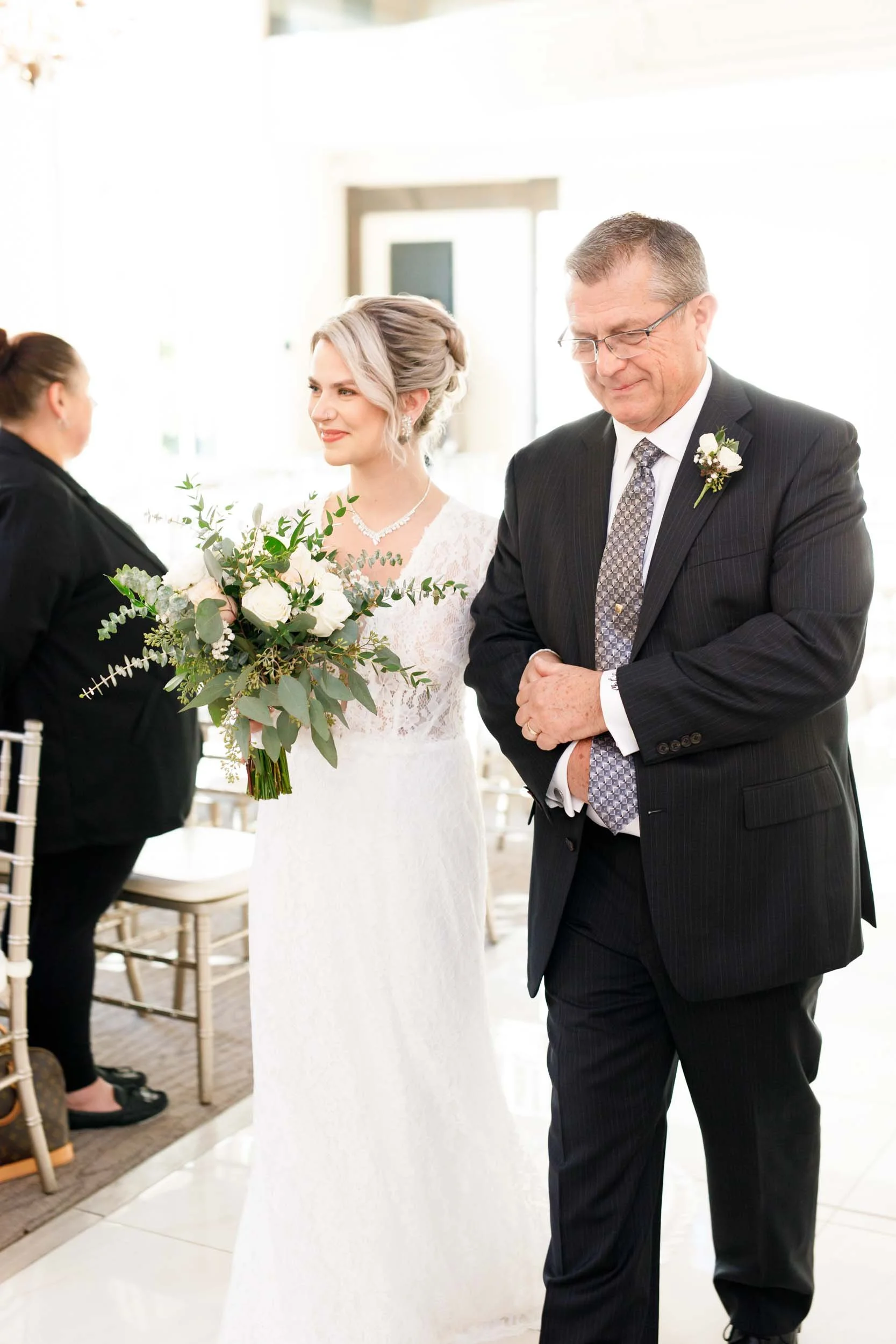 Bride walking down the aisle inside Miller’s Chapel at the Ancaster Mill