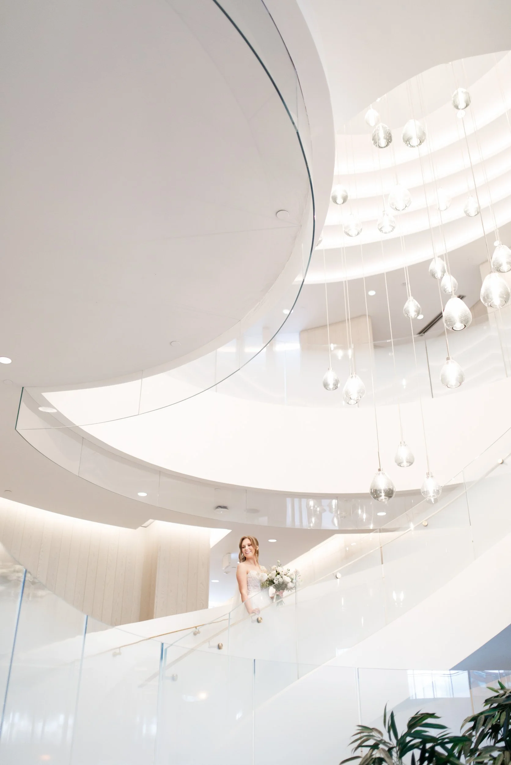 Bride on curved grand staircase inside The Pearle Hotel & Spa in Burlington, Ontario