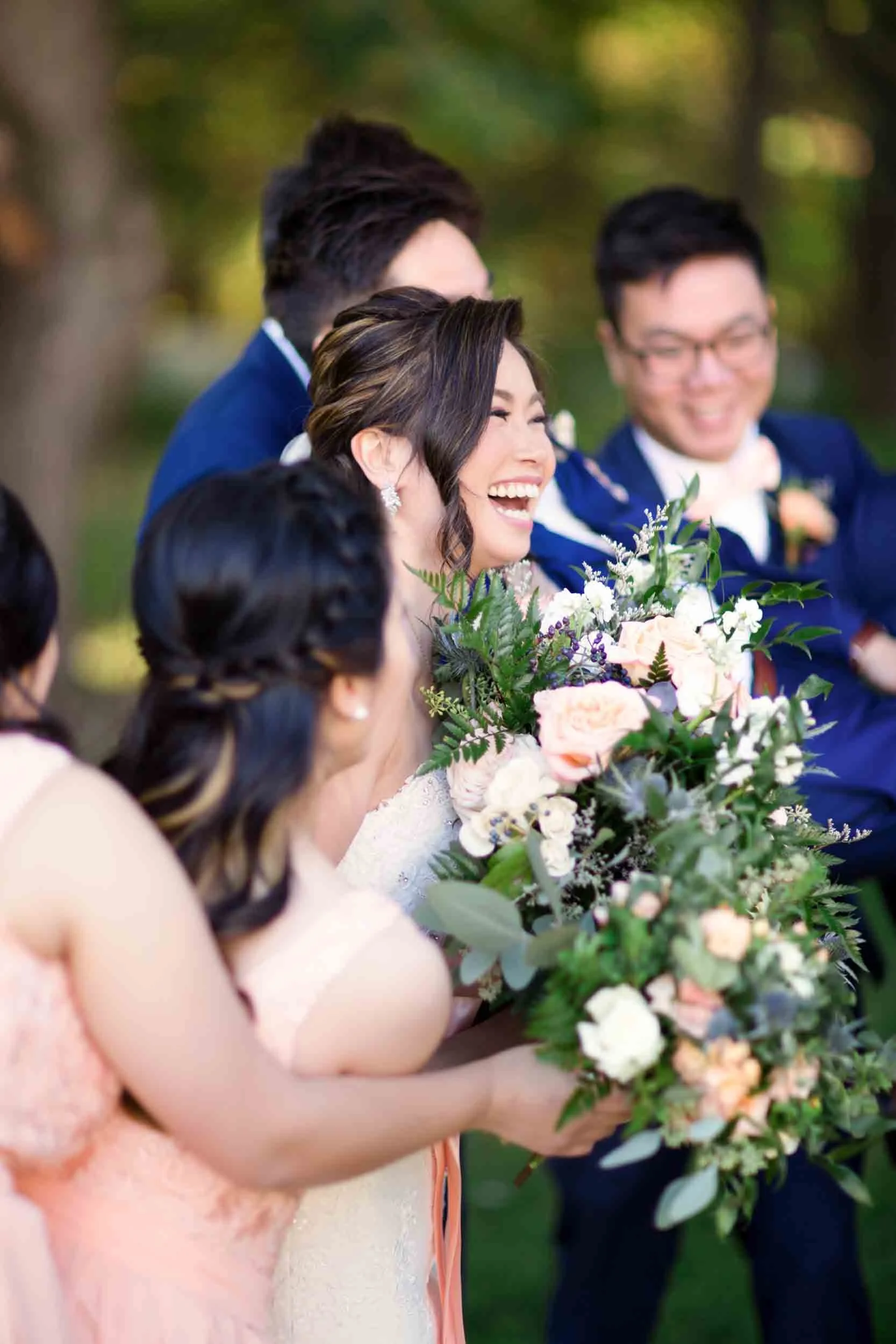 Bridal party laughter in garden courtyard at The Doctor’s House in Kleinburg, Ontario