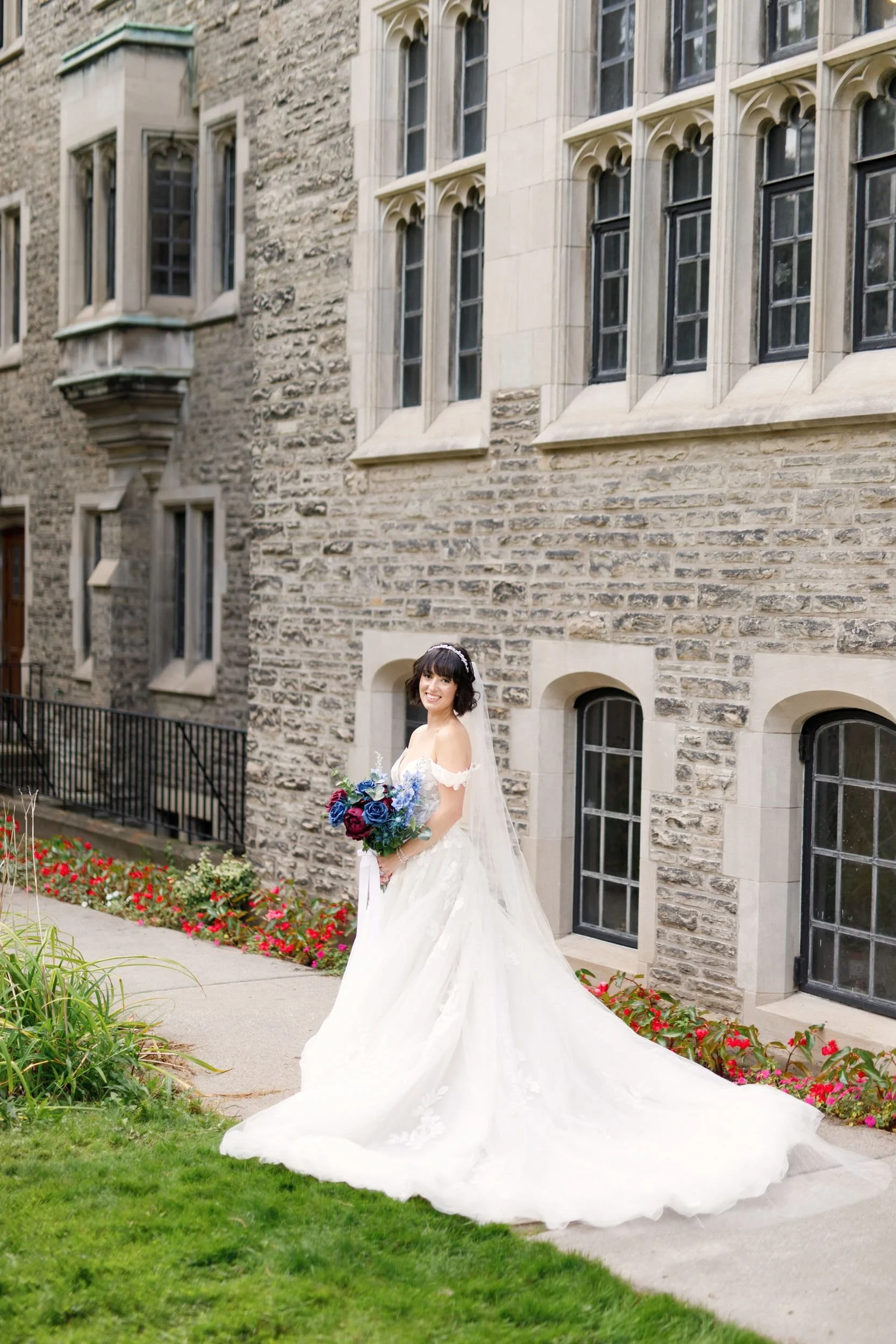 Bride walking along ivy-lined pathway at Victoria College, University of Toronto in Toronto, Ontario