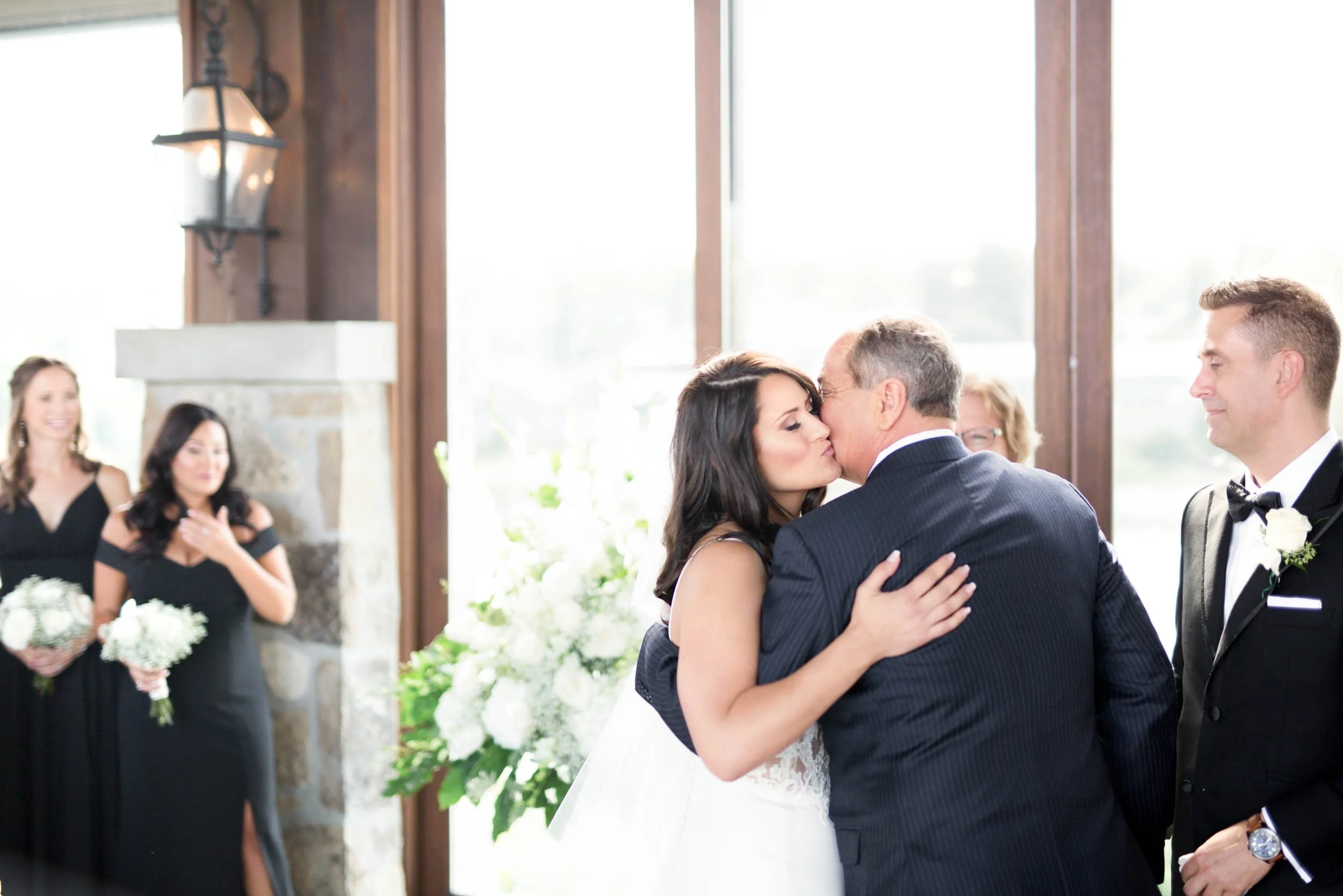 Father embracing bride during ceremony at Cambridge Mill wedding venue