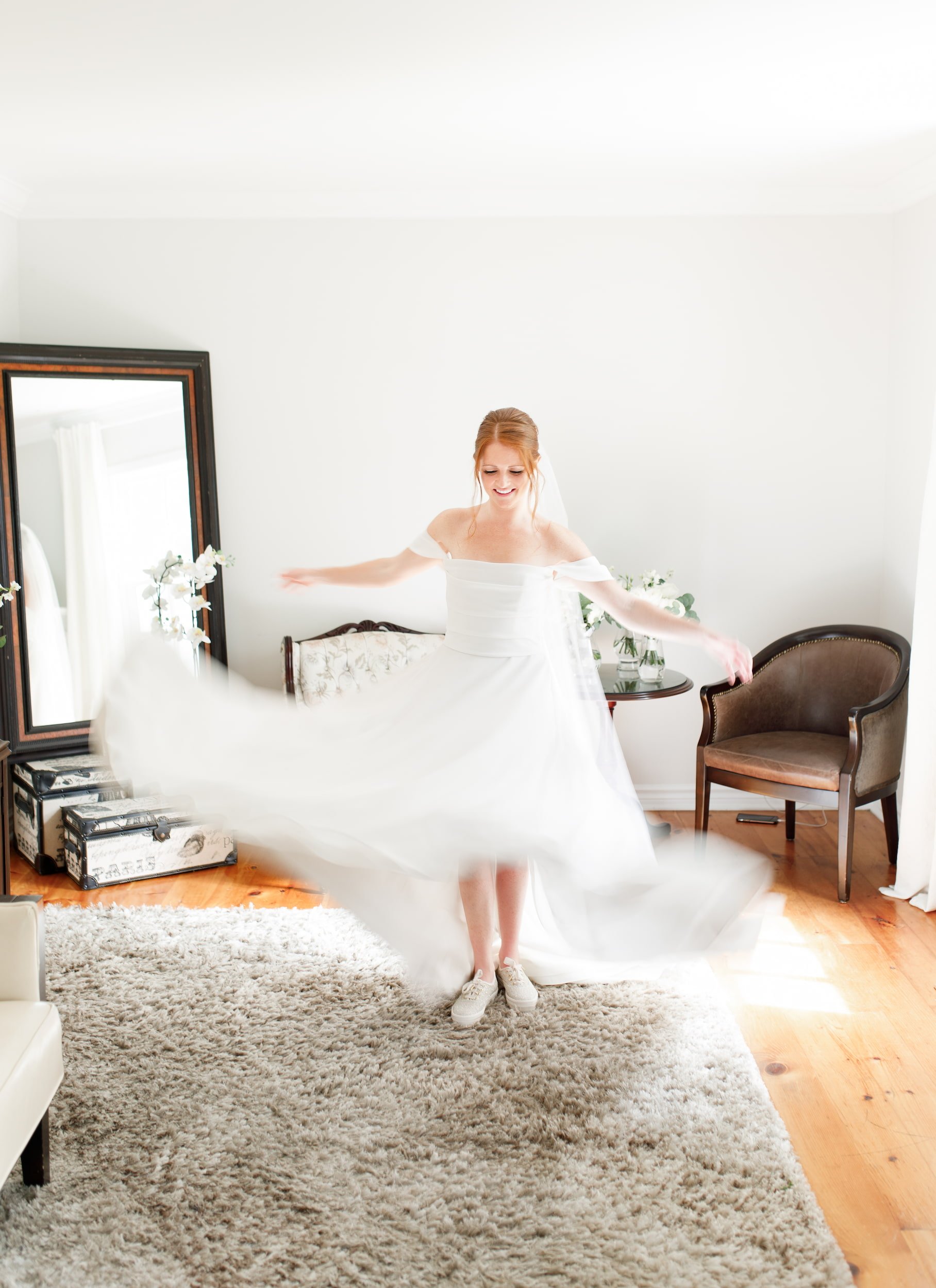 Motion blur bride twirling gown inside cottage suite at The Doctor’s House in Kleinburg, Ontario
