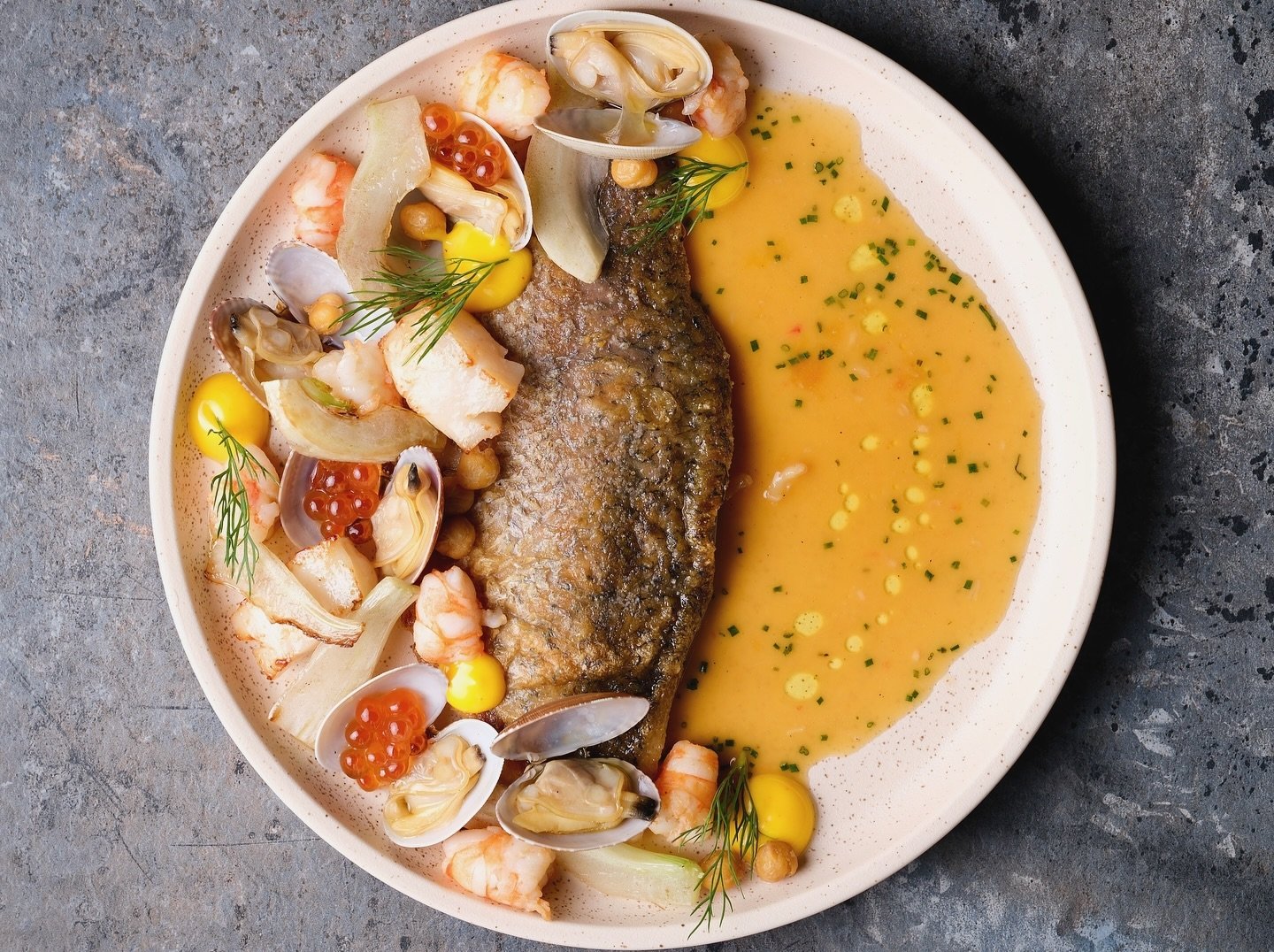 A plate with powerful flavours🍴

Pan-Seared Barramundi with bouillabaisse, clams, prawns, scallops, chickpeas, fennel and saffron aioli.