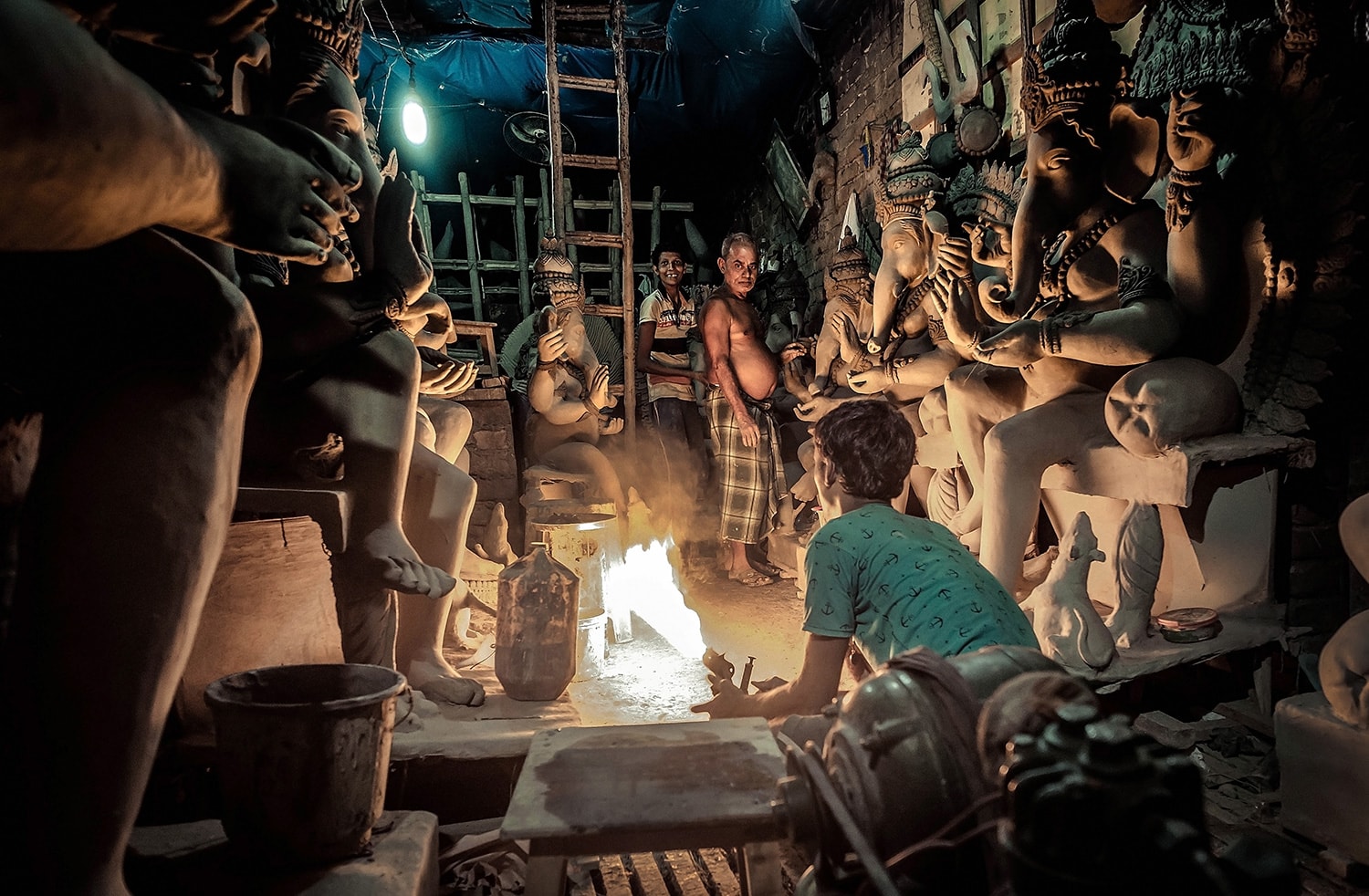 A boy attempts to quicken the drying with petrol - Fujifilm X-Pro2 & XF14mm at F3.2, 3200ISO, 60th