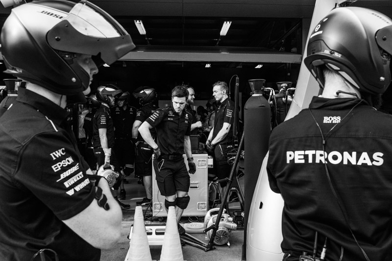 Mercedes AMG mechanics in Pit Lane wait for their car to come into the pits. Albert Park circuit in Melbourne, Australia.