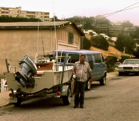 Laura's Dad Bob with a salmon, his Boston Whaler, and the family van 