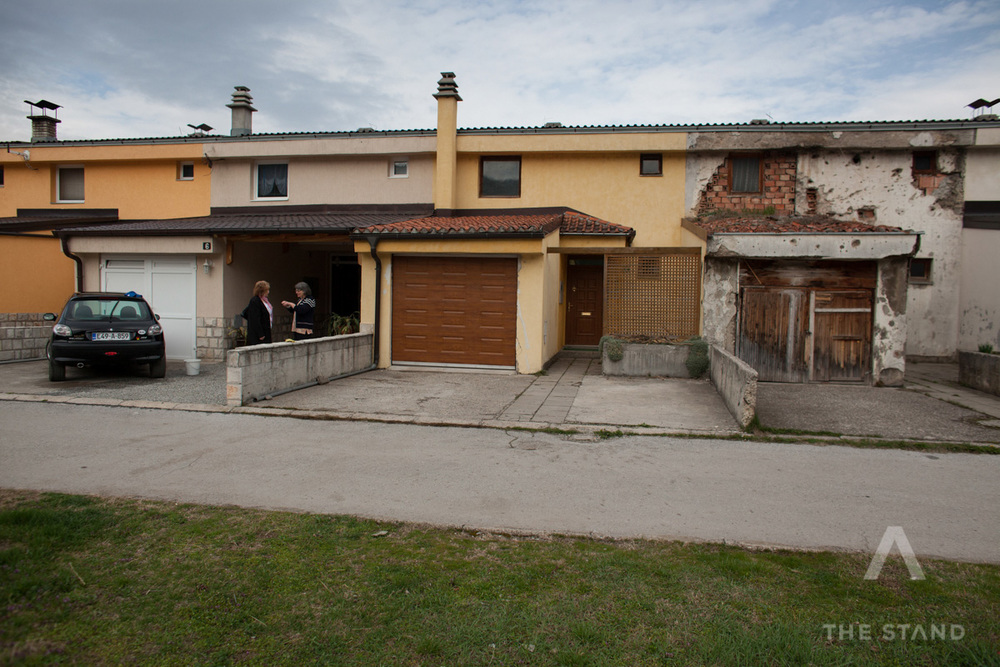  A war-scarred home that belonged to a Serbian man killed in the war now houses a displaced, homeless Bosnian woman. The homes on either side have been gentrified and refurbished by their Bosnian owners who have bought the properties. Gorazde, Bosnia