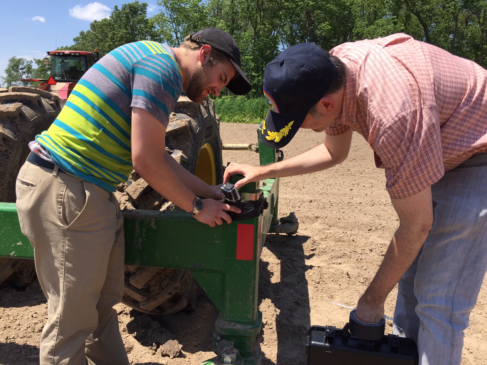 DP Todd Norris and digital assistant Brock Masters strap a GoPro camera to this Kelly Diamond Harrow before it heads back out in to a cornfield.
