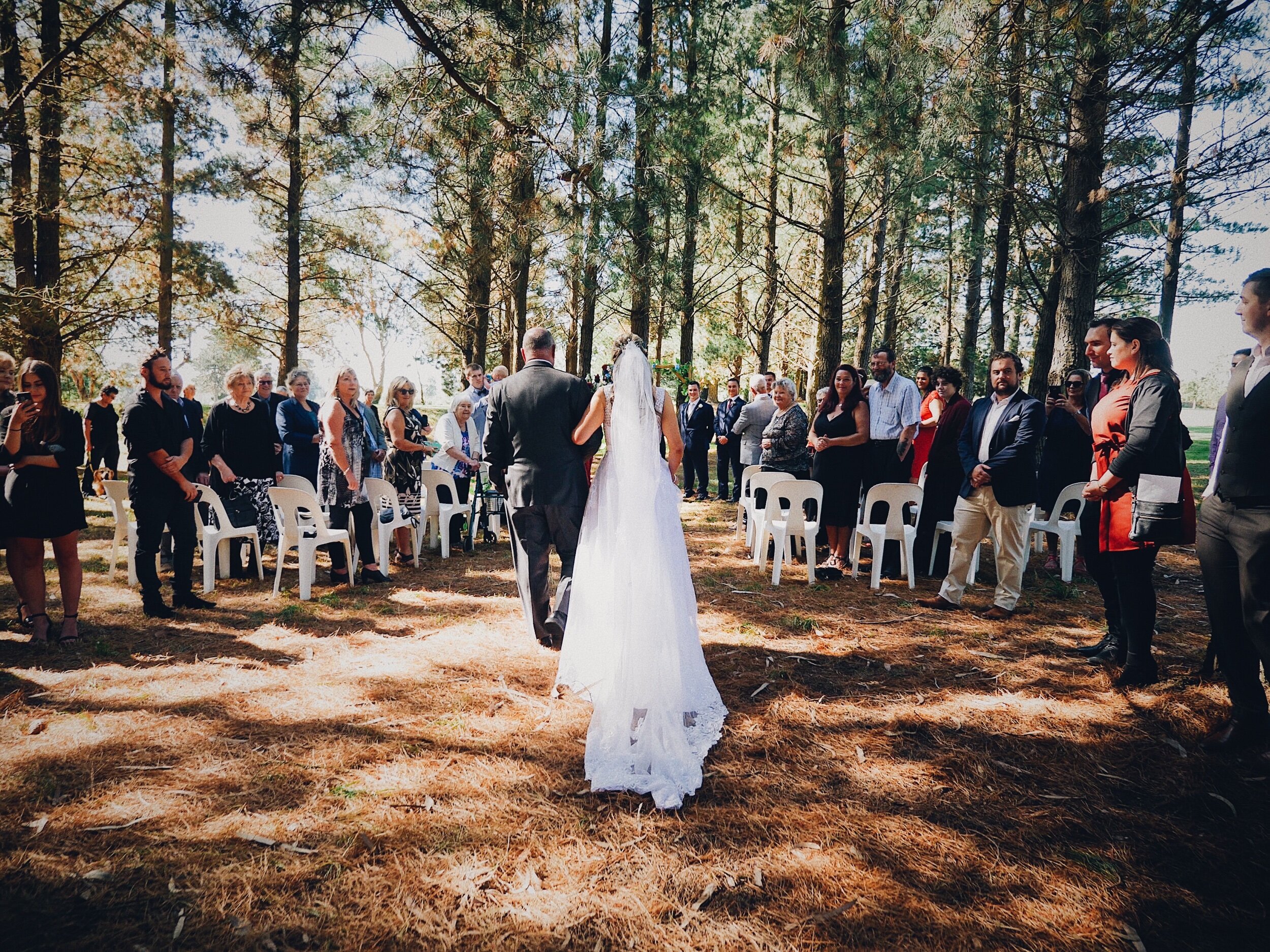 I really dig how this shot came out. I love this perspective - following the bride up the aisle and capturing everyone else looking on.