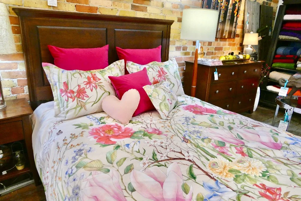 "In Bloom" bedding by Revelle with hot pink accent cushions.