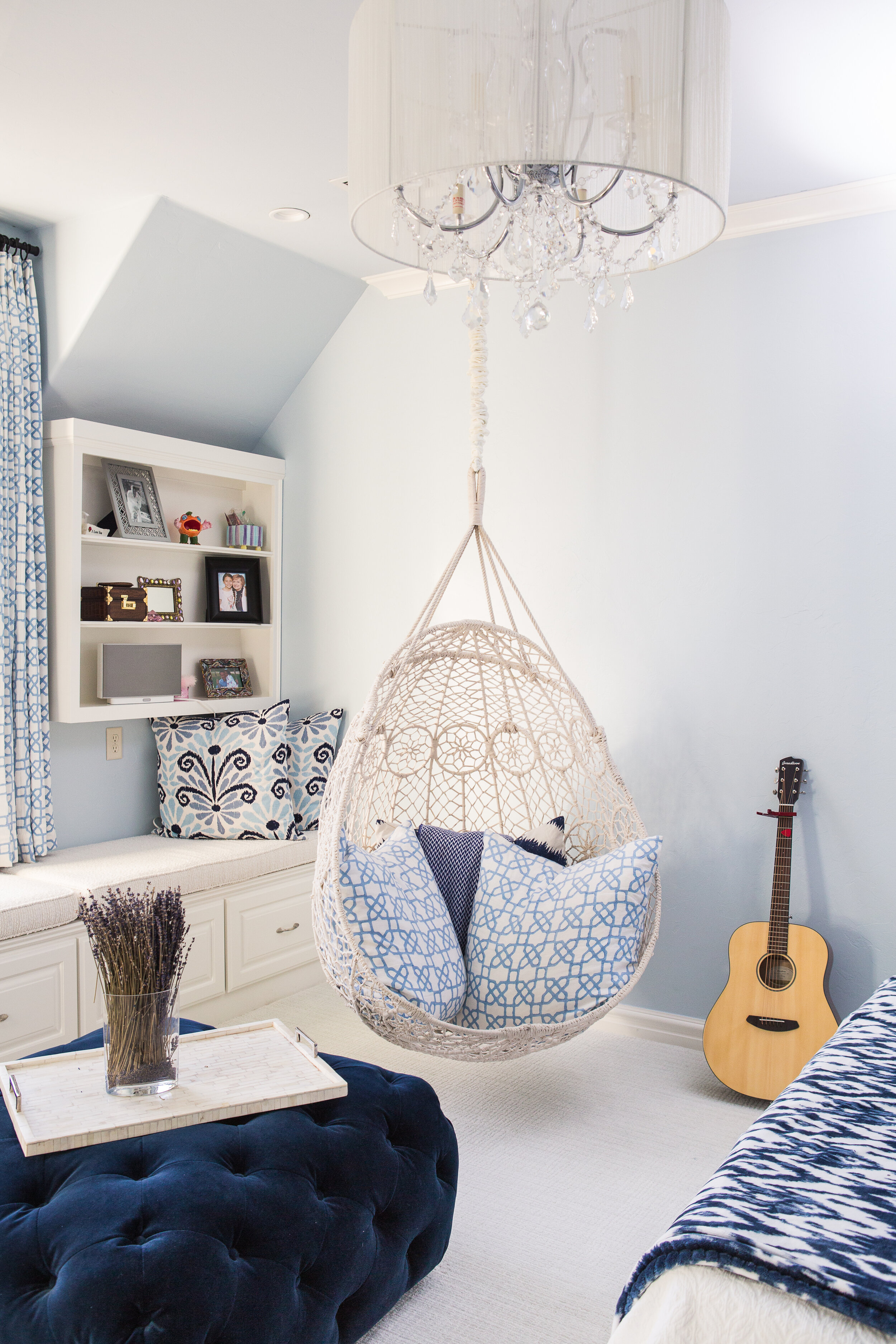  young girl’s bright blue bedroom with a hanging chair 