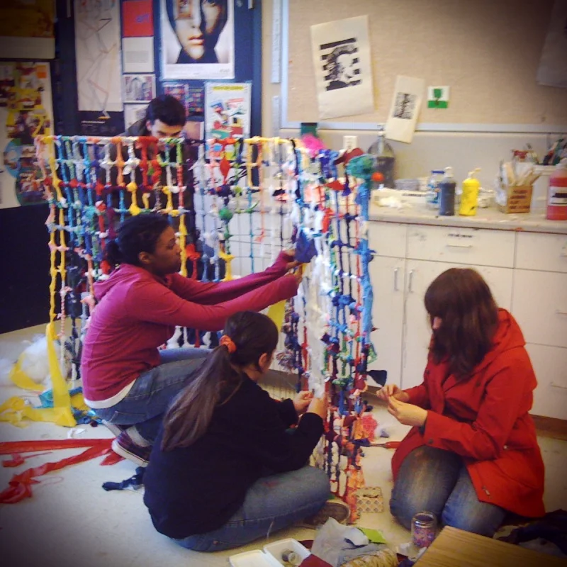 Making a sculpture from a recycled wire form and scraps of fabric.