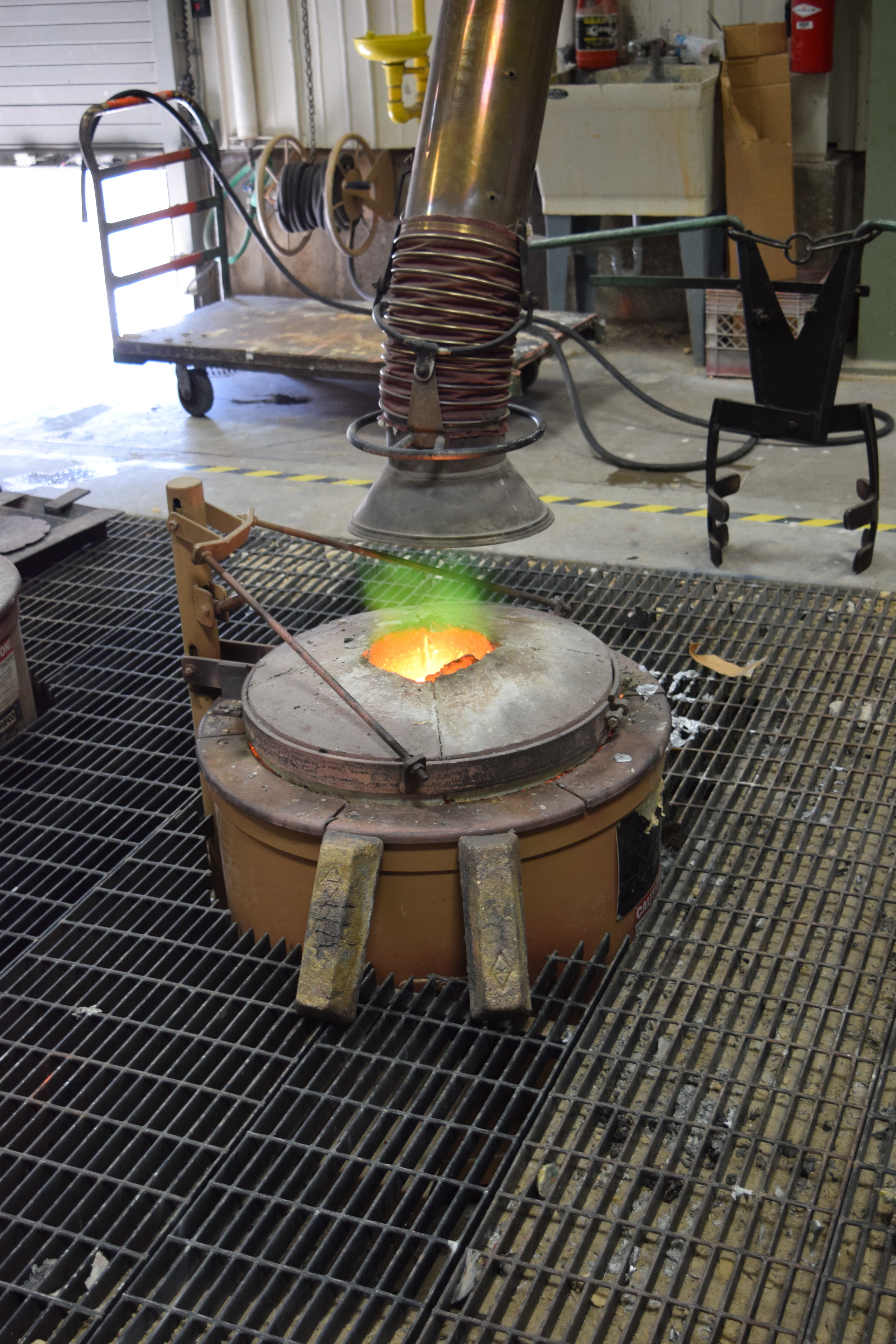  The forge heating up with bronze ingots. 