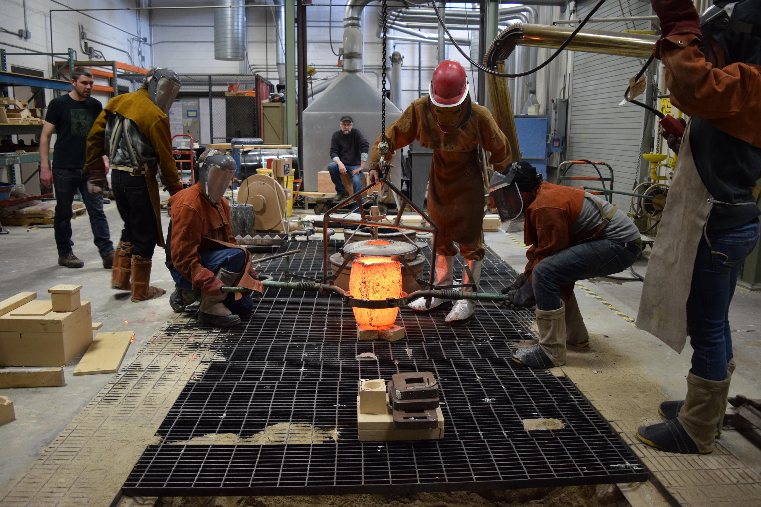  The crucible is lowered into the cradle and the crane is attached. 