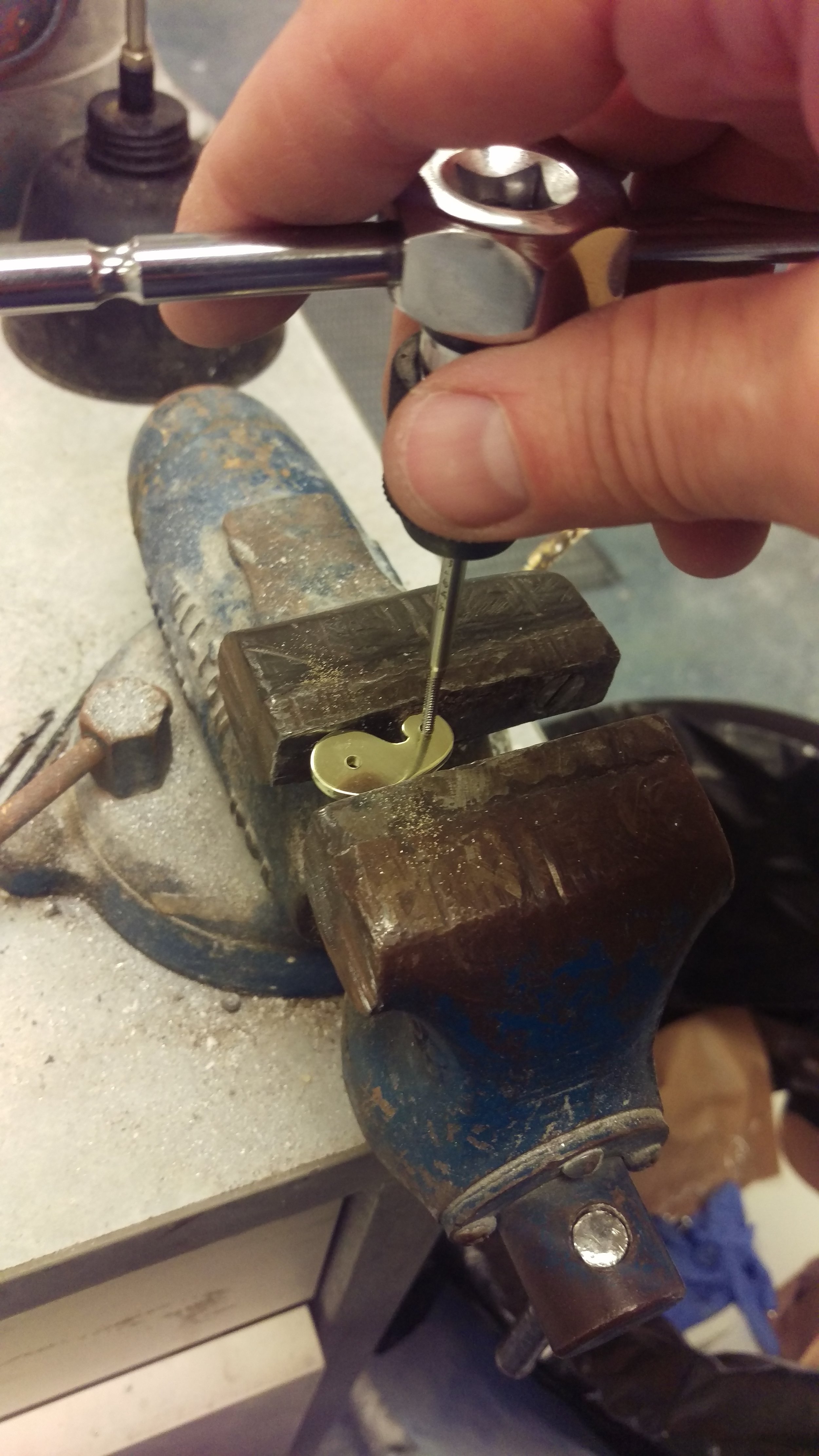  Working on the tiny brass hand crank. 