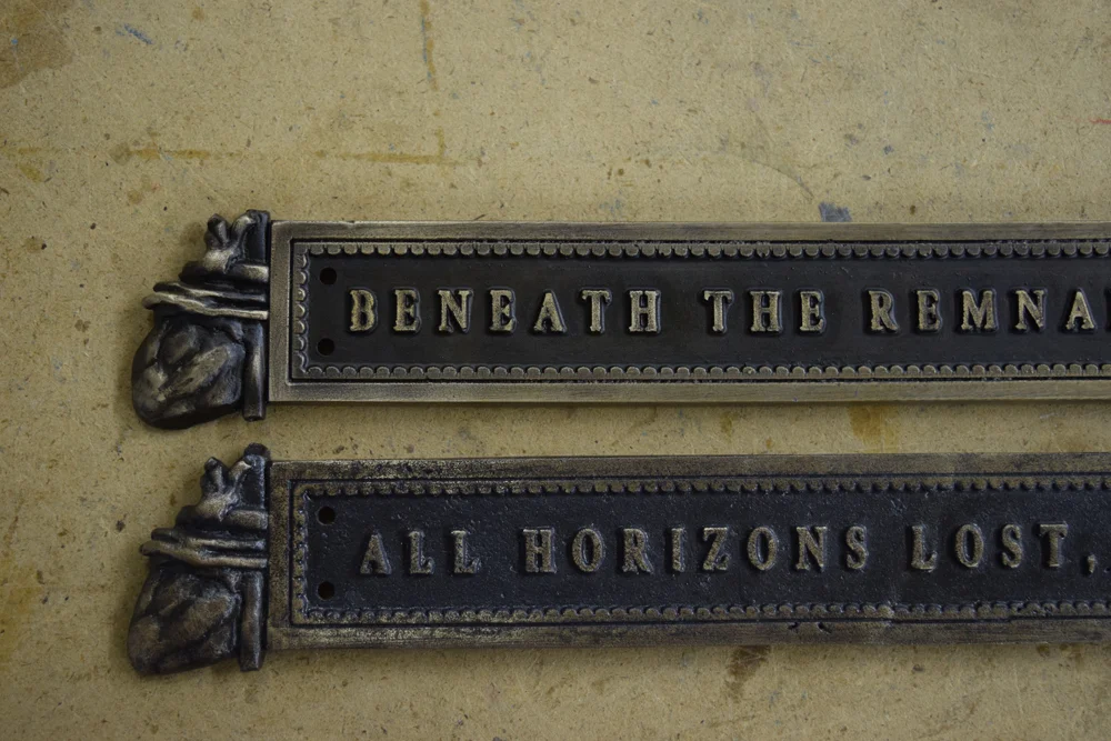 Comparison of the new title plate (top) and the original.