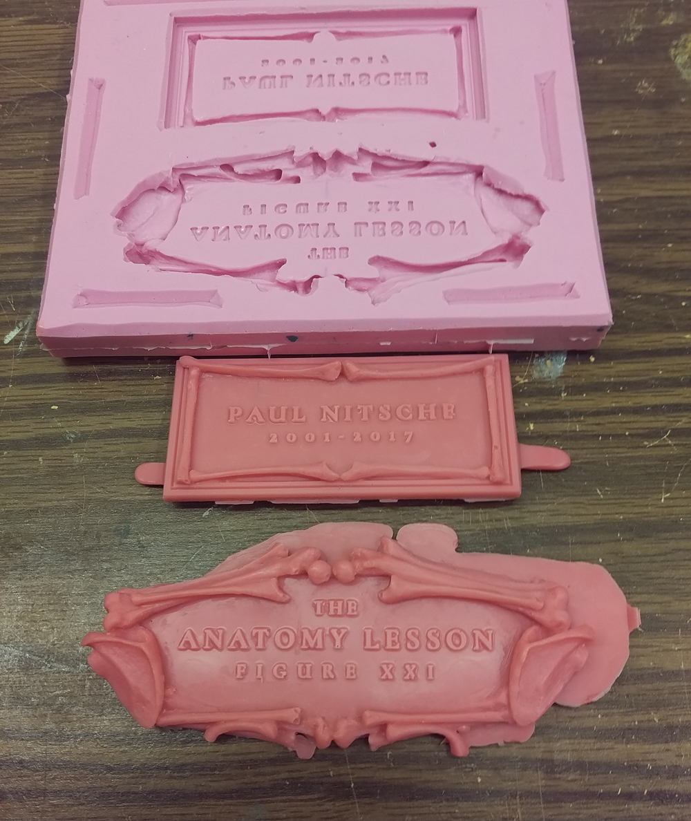  The silicone mold and rough waxes for the title and name plates. 