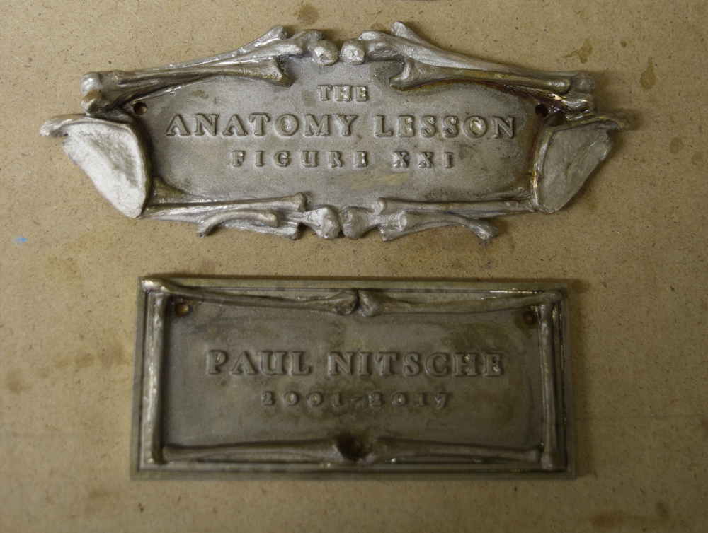  The bronze title and name plate castings after imperfections are ground and smoothed out. 