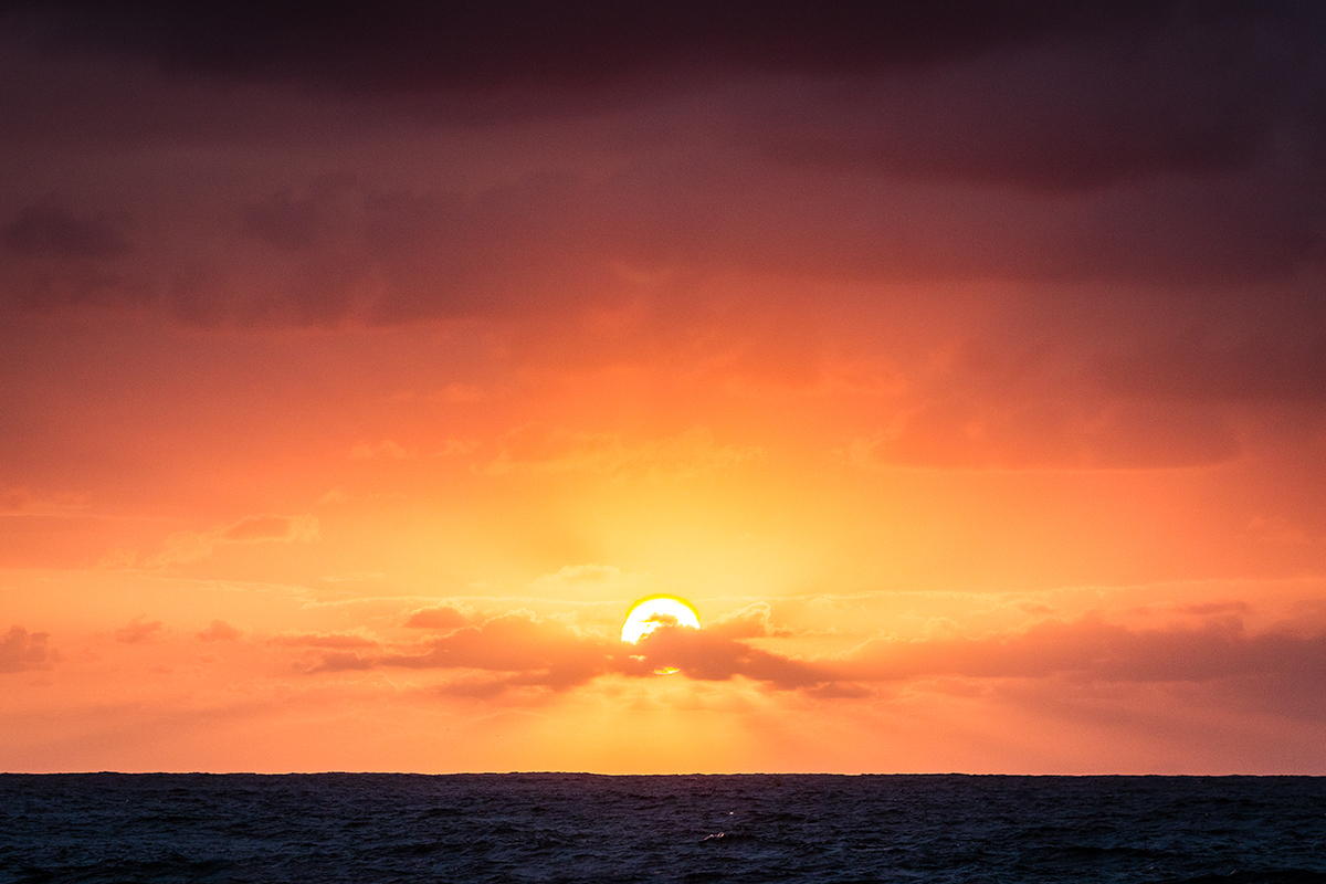 Sun rays bursting through the thin cloud.