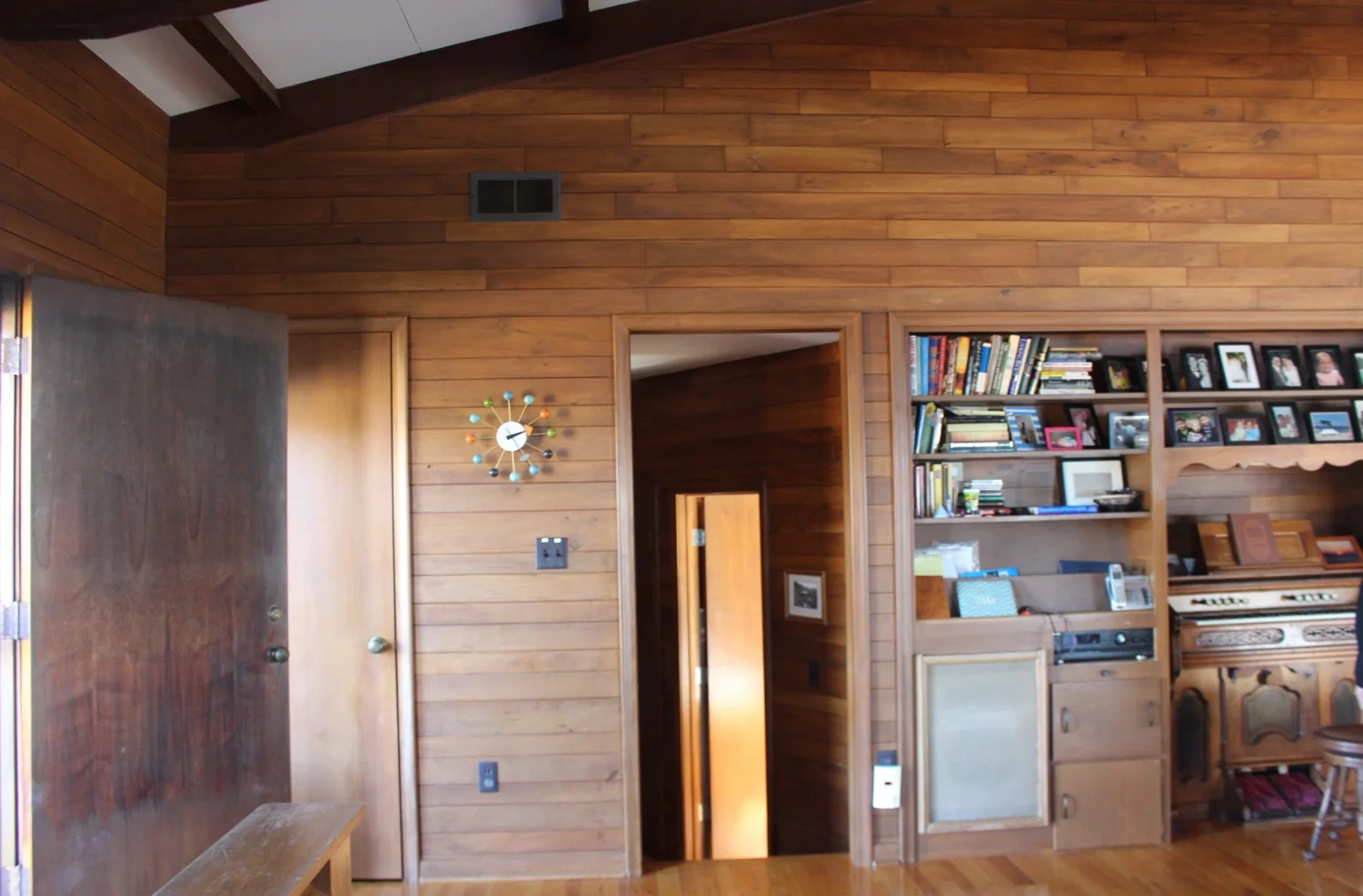 Hall to main floor bedrooms with view of wall niche and organ James often played