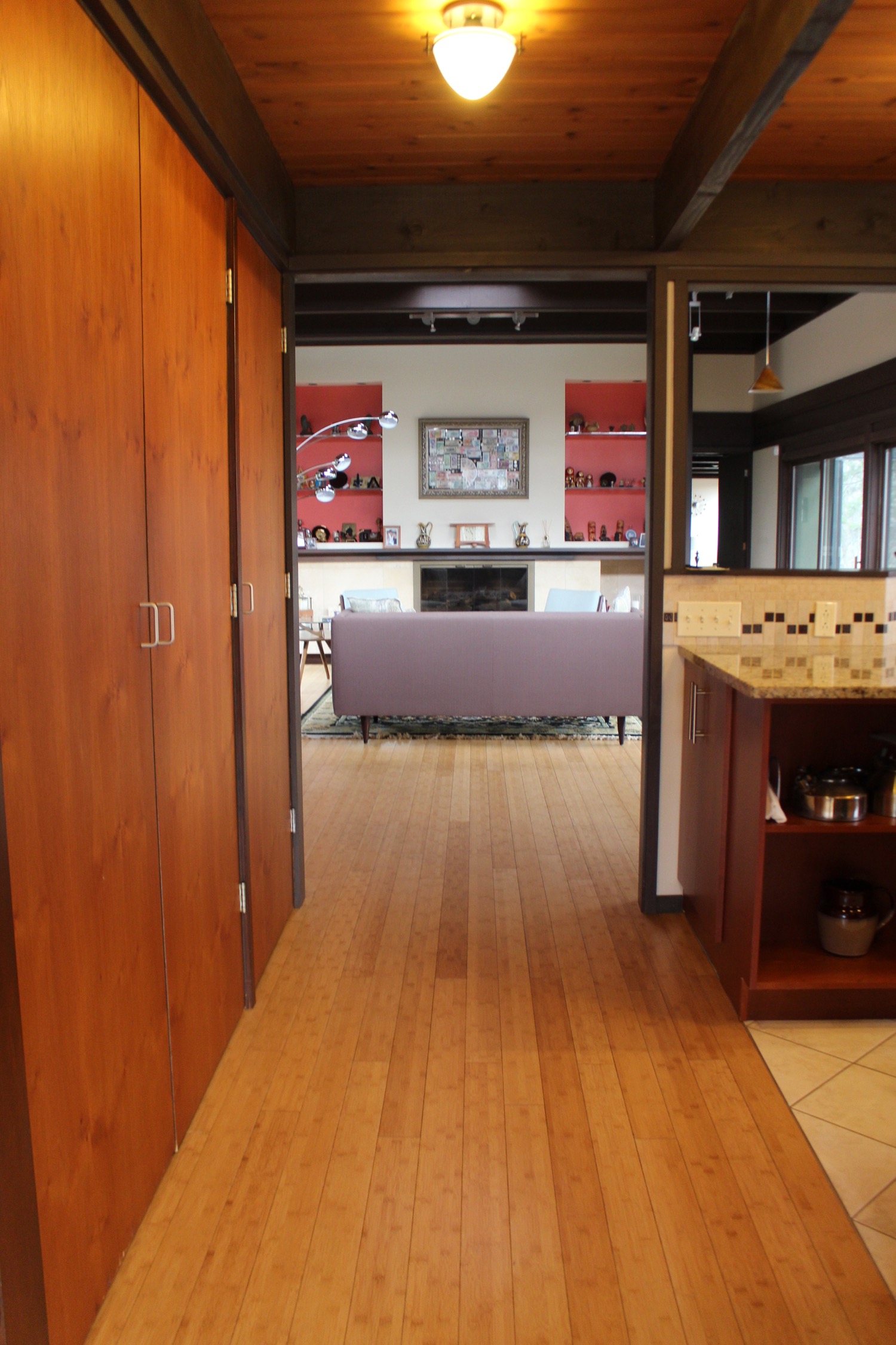 COZY HALL, NEW BAMBOO FLOORS, LOVEY ORIGINAL BUILT-INS DIRECT US THROUGH TO THE VAULTED LIVING ROOM