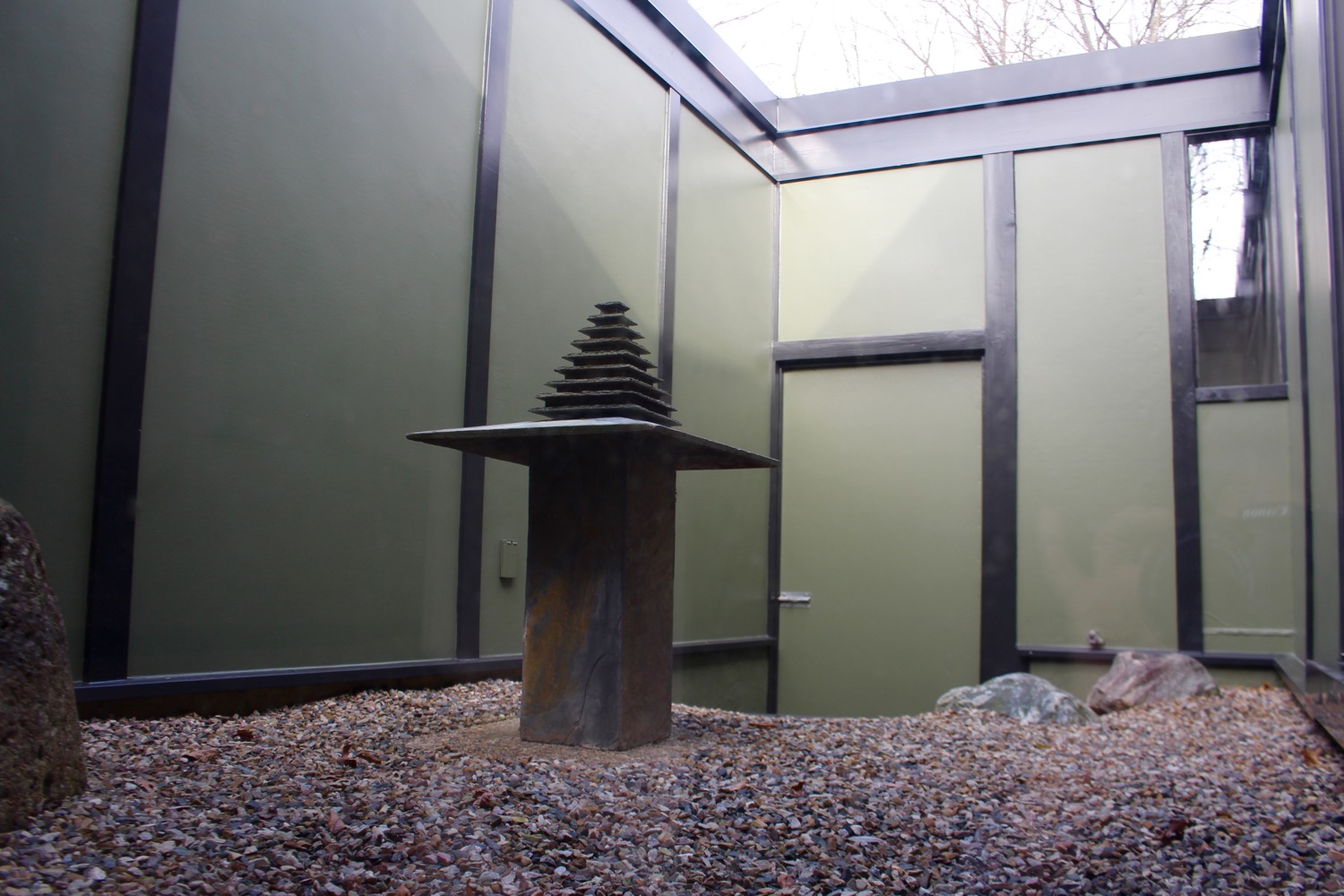 GLASS SLIDERS FROM THE LIVING ROOM LEAD TO A QUIET INNER COURTYARD FOR MEDITATION AND CONTEMPLATION