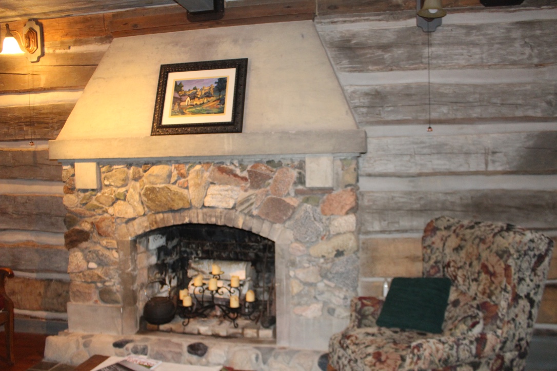 Cabin interior with fireplace designed by Manierre and cabin walls re-chinked by current owner Sharon Bluhm