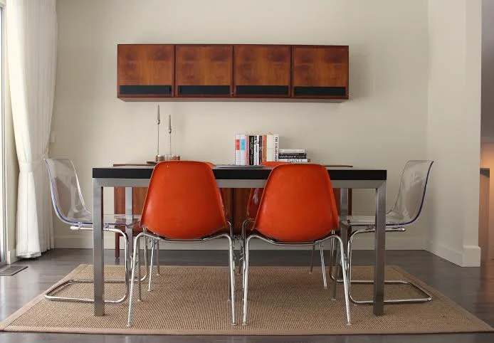 The Fox Family's dining room in their modern ranch home was furnished with a combination of contemporary furniture and vintage danish modern sideboard and cupboard.