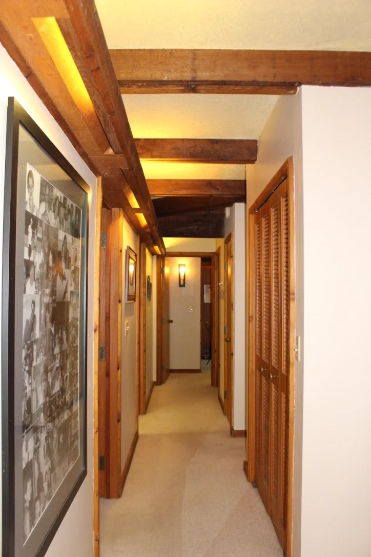 BEDROOM HALLWAY WITH GOOD VIEW OF BEAM STRUCTURE WITH BUILT IN AMBIENT FLUORESCENT LIGHTING.