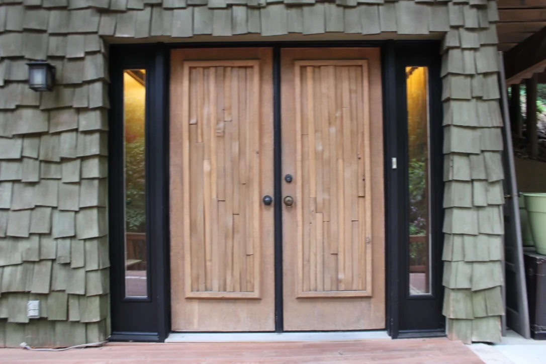 Glass lights flank the cedar covered double doors and create an inviting entry. 