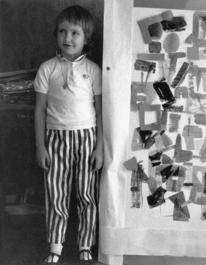 Daughter Laurel Firant, at a young age, next to Gerda's painting.