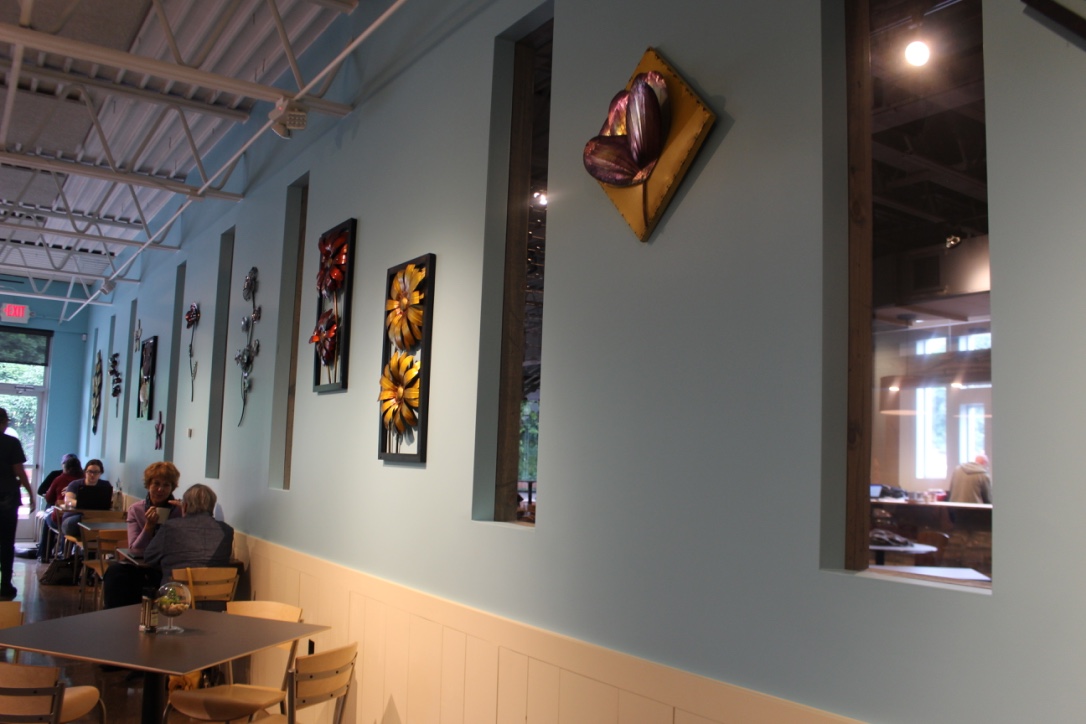 Metal wall art add to the 1960's vibe in Little Lucy's Cafe