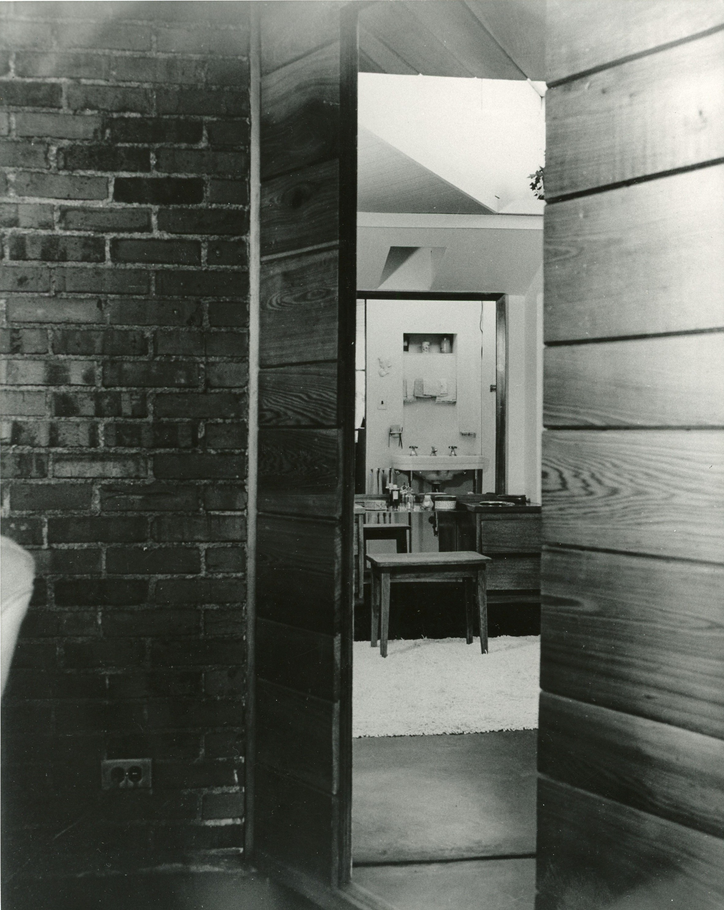 Door to hall and bathroom is hidden in the wall of cypress panelling.