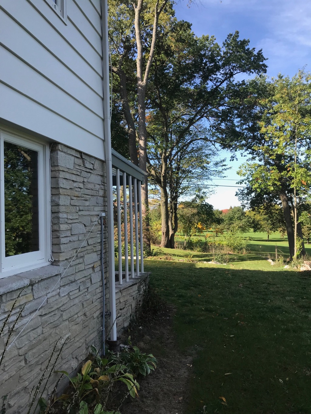 SIDE EXTERIOR WITH VIEW OF COUNTRY CLUB BEYOND