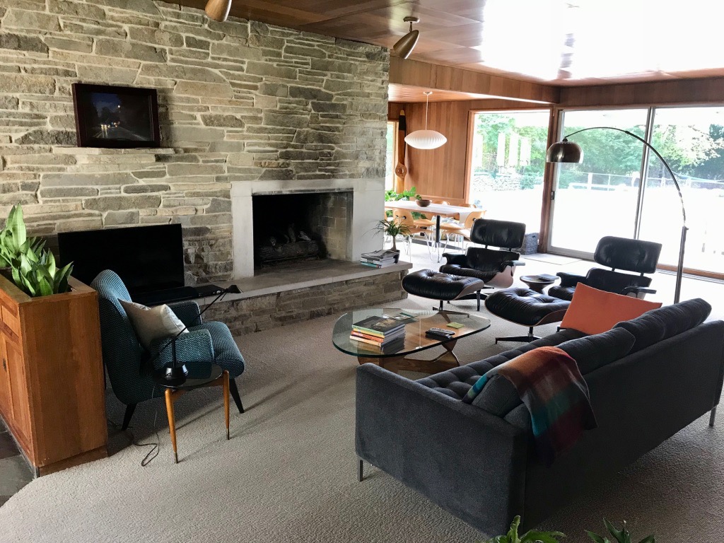 LIVING ROOM WITH CUT-STONE FIREPLACE WALL