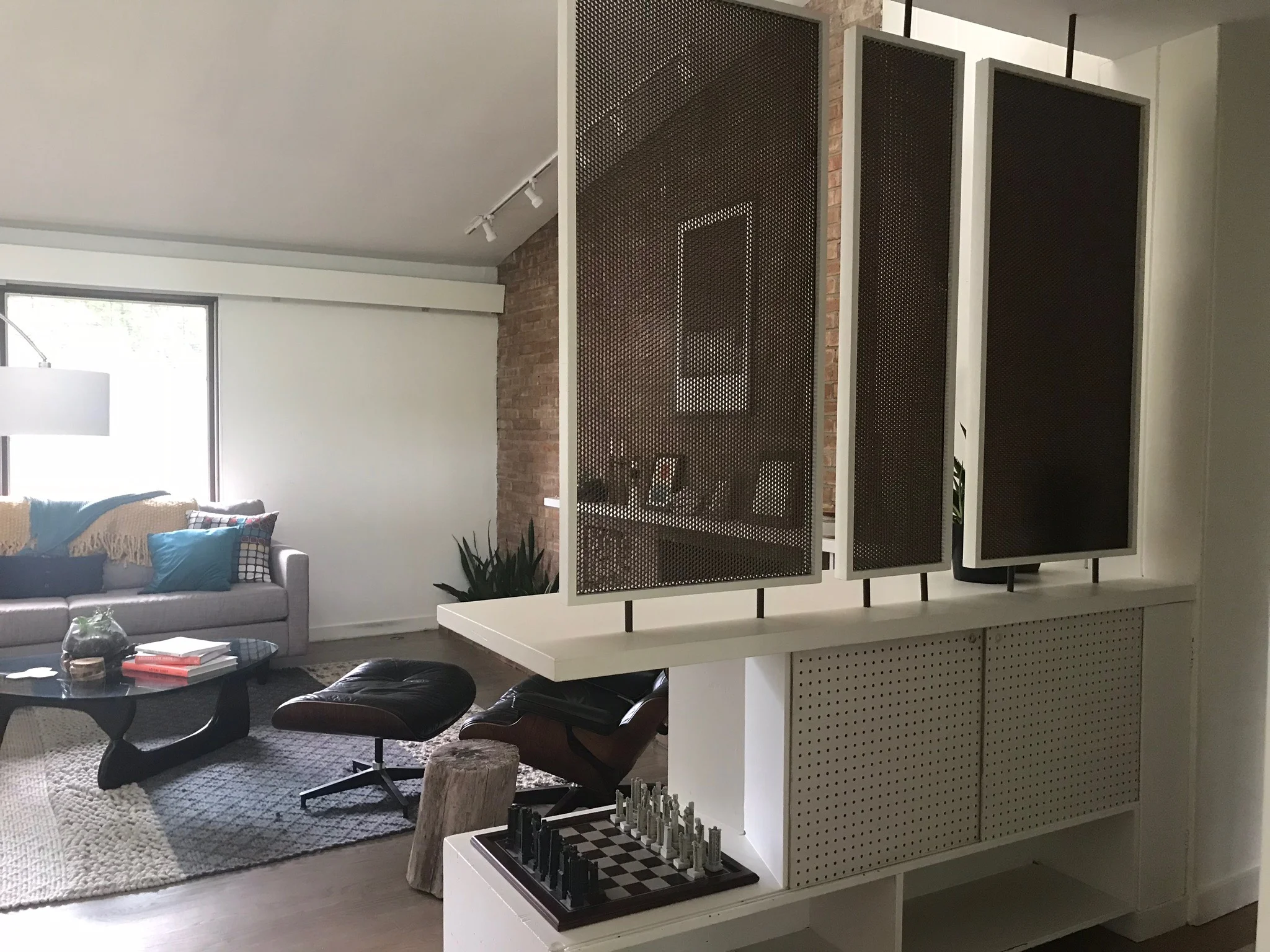 INDUSTRIAL SCREENS SEPARATE LIVING ROOM AND FOYER