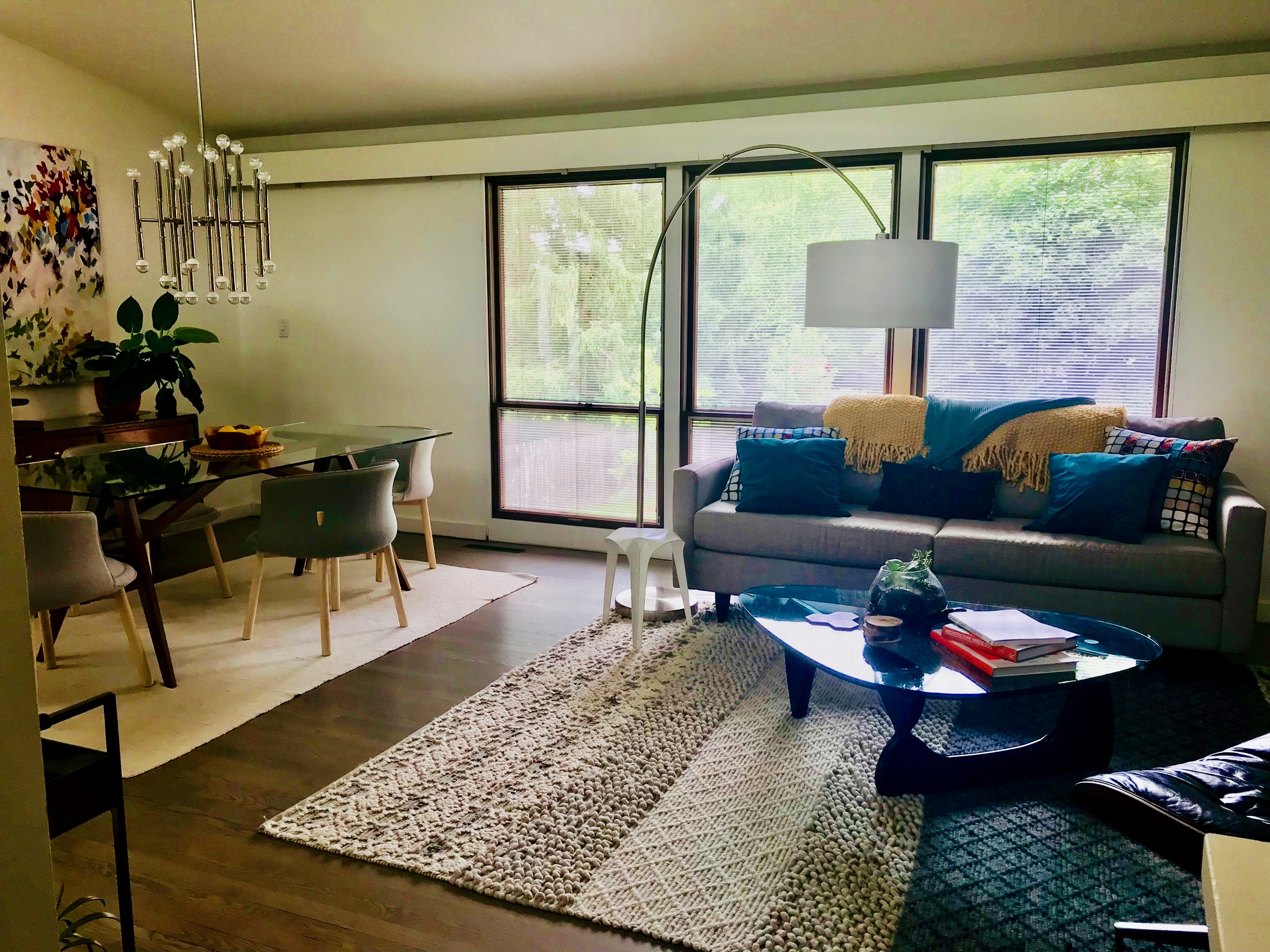 OPEN CONCEPT LIVING - DINING SPACE WITH WINDOWS OVERLOOKING THE BACKYARD