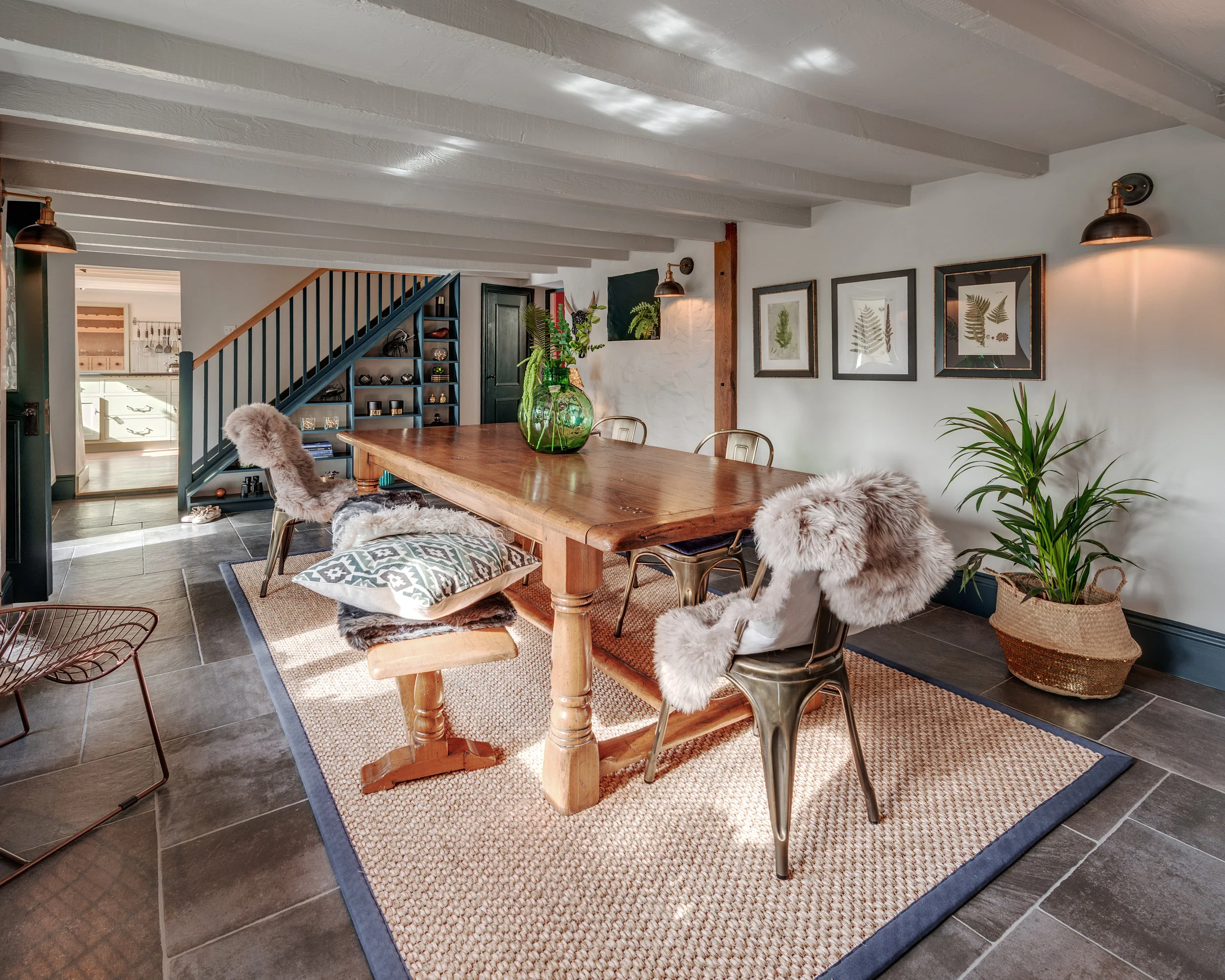 The Bulrushes, dining area with natural rug and greenery a plenty. 