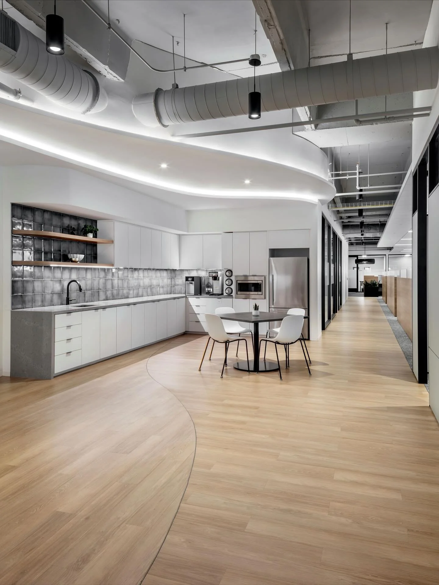 LAN&rsquo;s Houston office has curved ceiling lights that lead down the corridor toward the executive suites, where a dedicated client lounge provides a comfortable waiting area. The lighting design has a fun visual aspect and seamlessly connects key