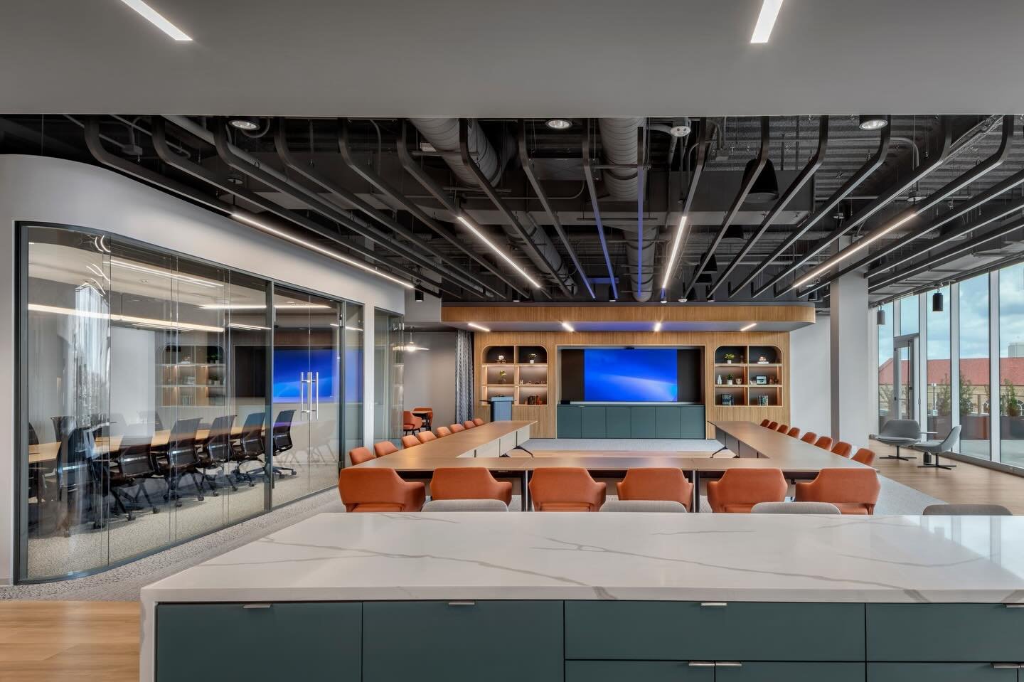 Final Project Photos for our confidential energy client! This 6,300 SF office space is used as a common meeting area for all employees to use. There is ample seating throughout - from a conference room to a private phone booth to a public meeting are
