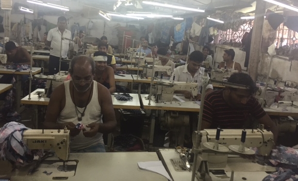 Garment stitchers in the Dharavi slum in Mumbai, Maharashtra, India.
