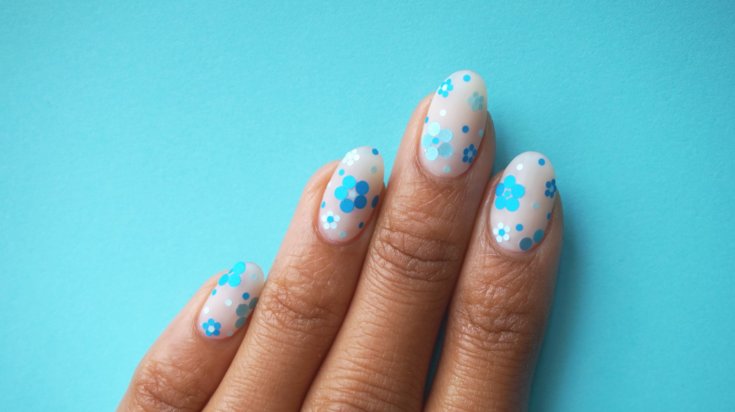 Theme: Color. I interpreted this theme as using one color so I decided to go with Blue. Flowers done with loose glitter pieces. This design looks great as an accent nail or on all 10 fingers!