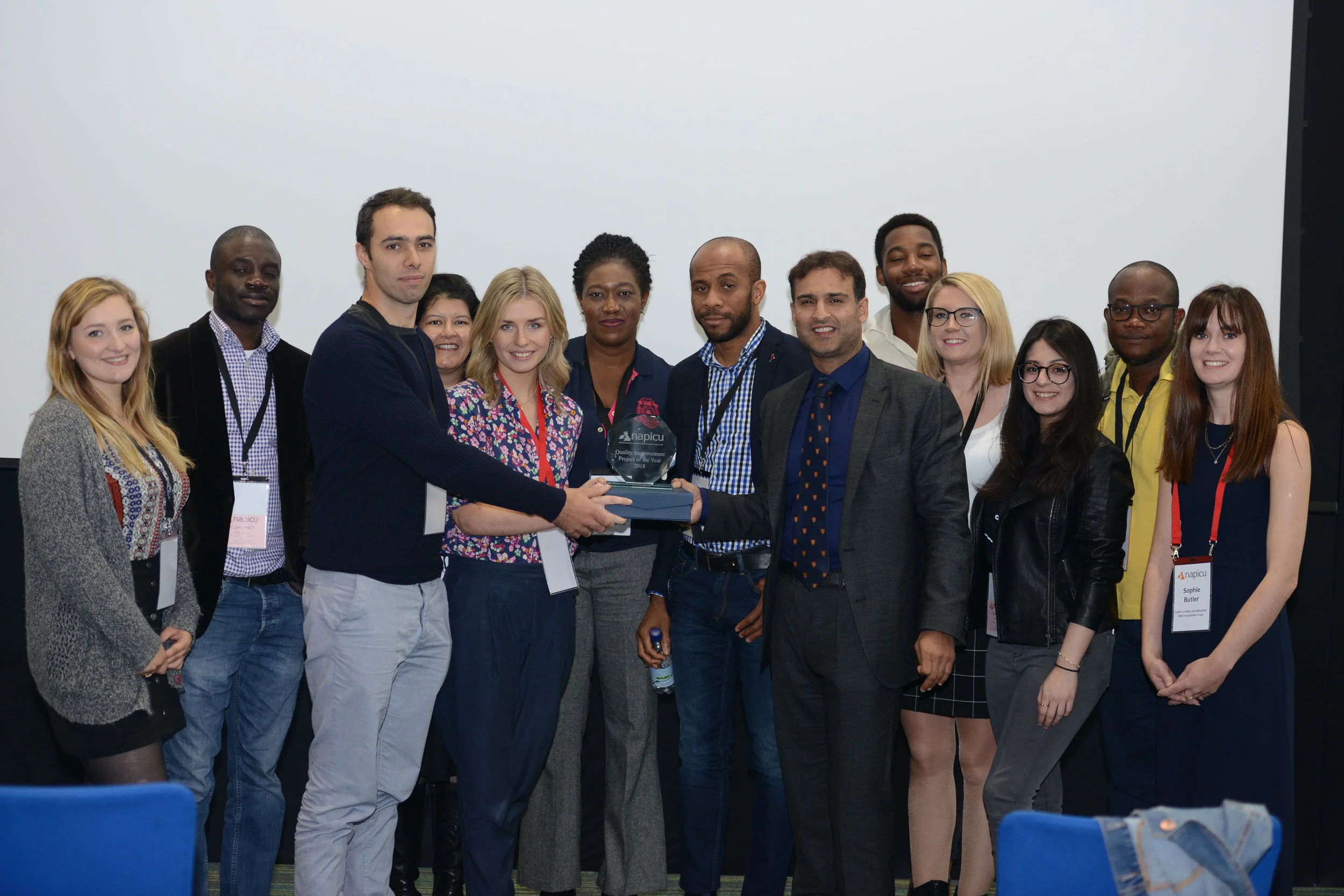 Hospital Rooms’ founders Tim A Shaw and Niamh White celebrate winning NAPICU Quality Improvement project of the year with members of the team from Eileen Skellern 1, including consultant psychiatrist Dr Faisil Sethi, ward manager Onyeka Nwankwo, occupational therapist Rebecca Davies, and SPR Dr Sophie Butler.